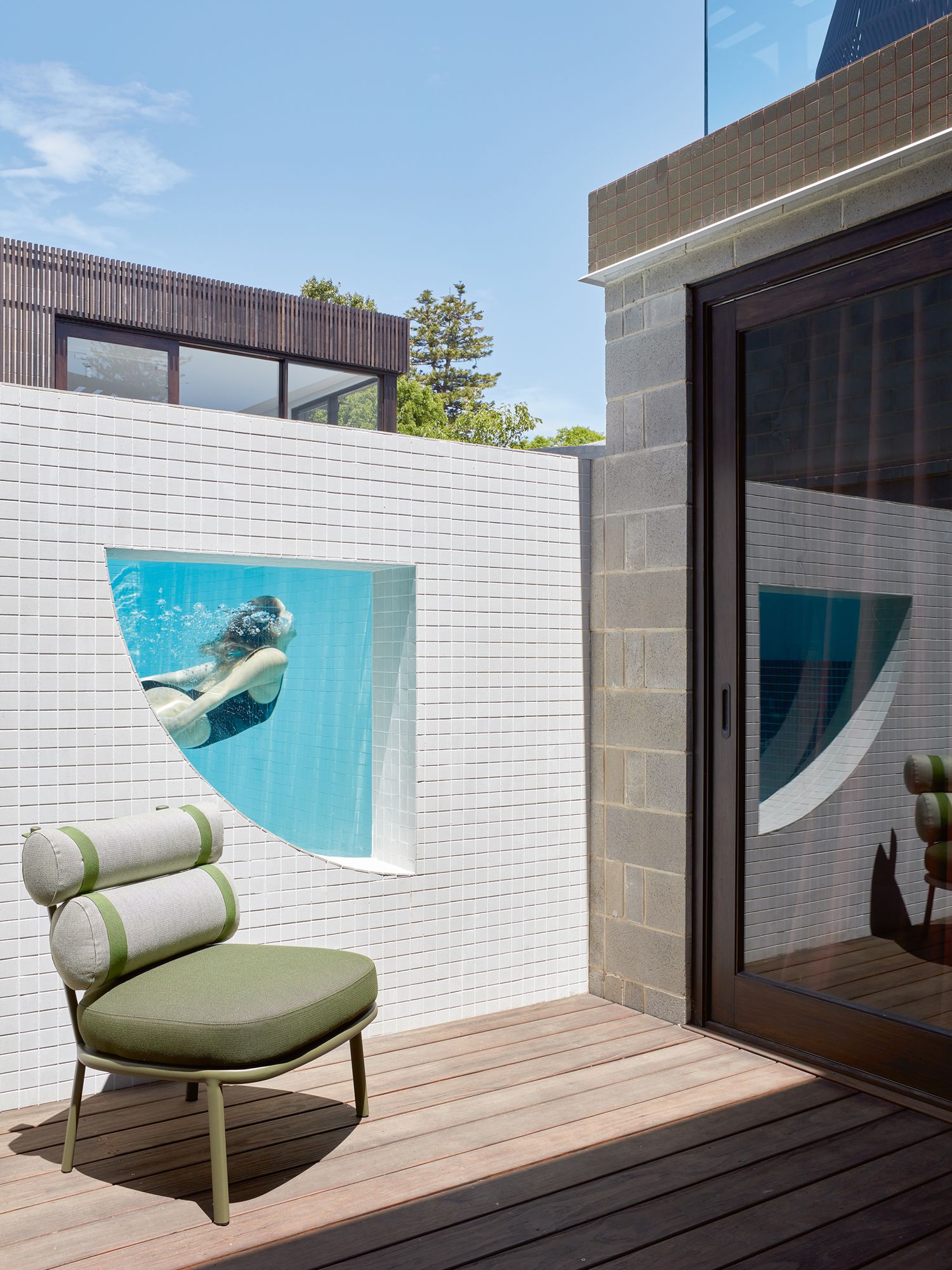 A window in the pool wall offers glimpses of aquatic activity from the courtyard