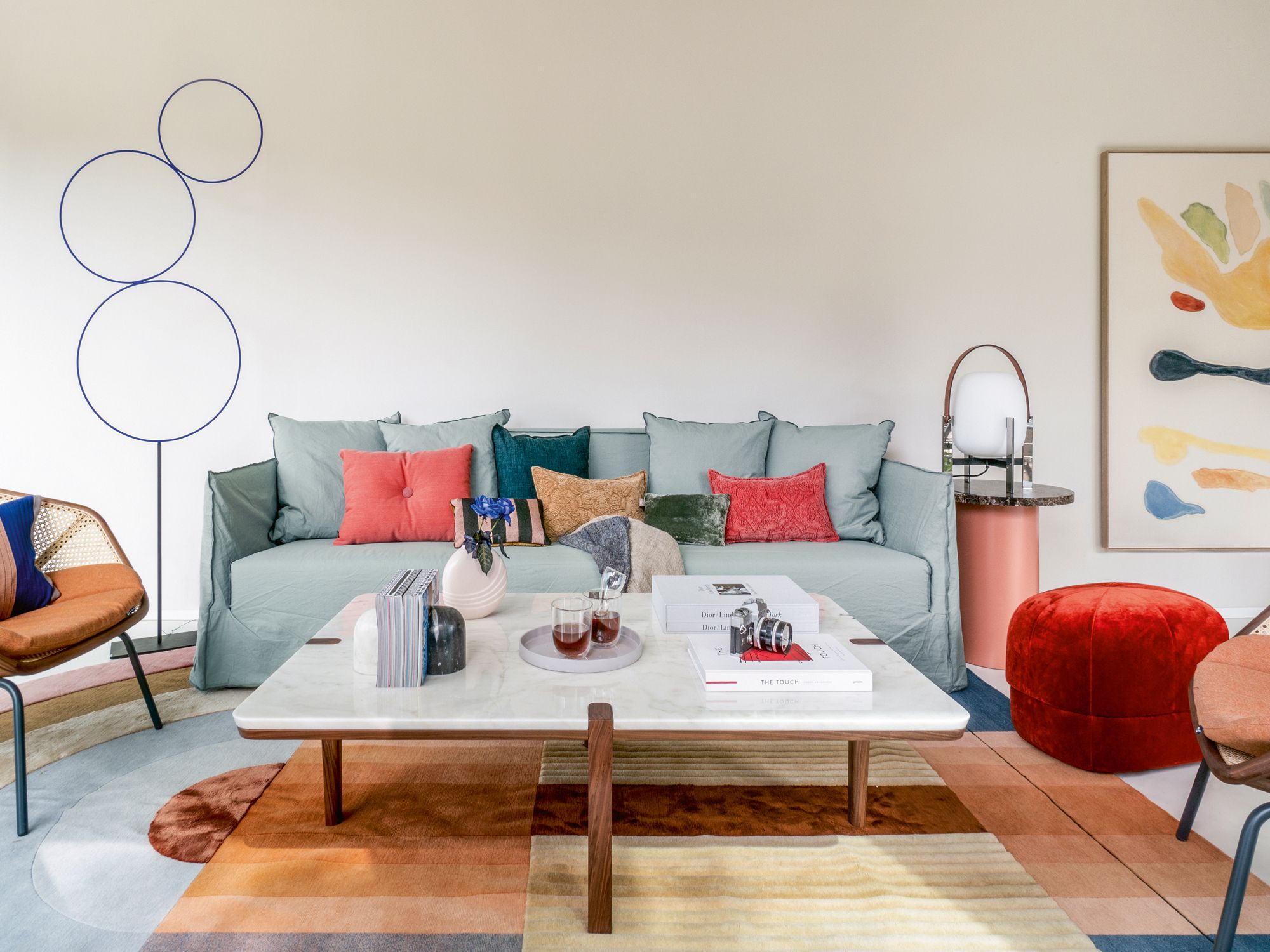 The living room is furnished with the Gervasoni Ghost sofa, Miniform armchairs, We Wood coffee table, Normann Copenhagen pouf, Santa & Cole lamp and E15 Enoki side table