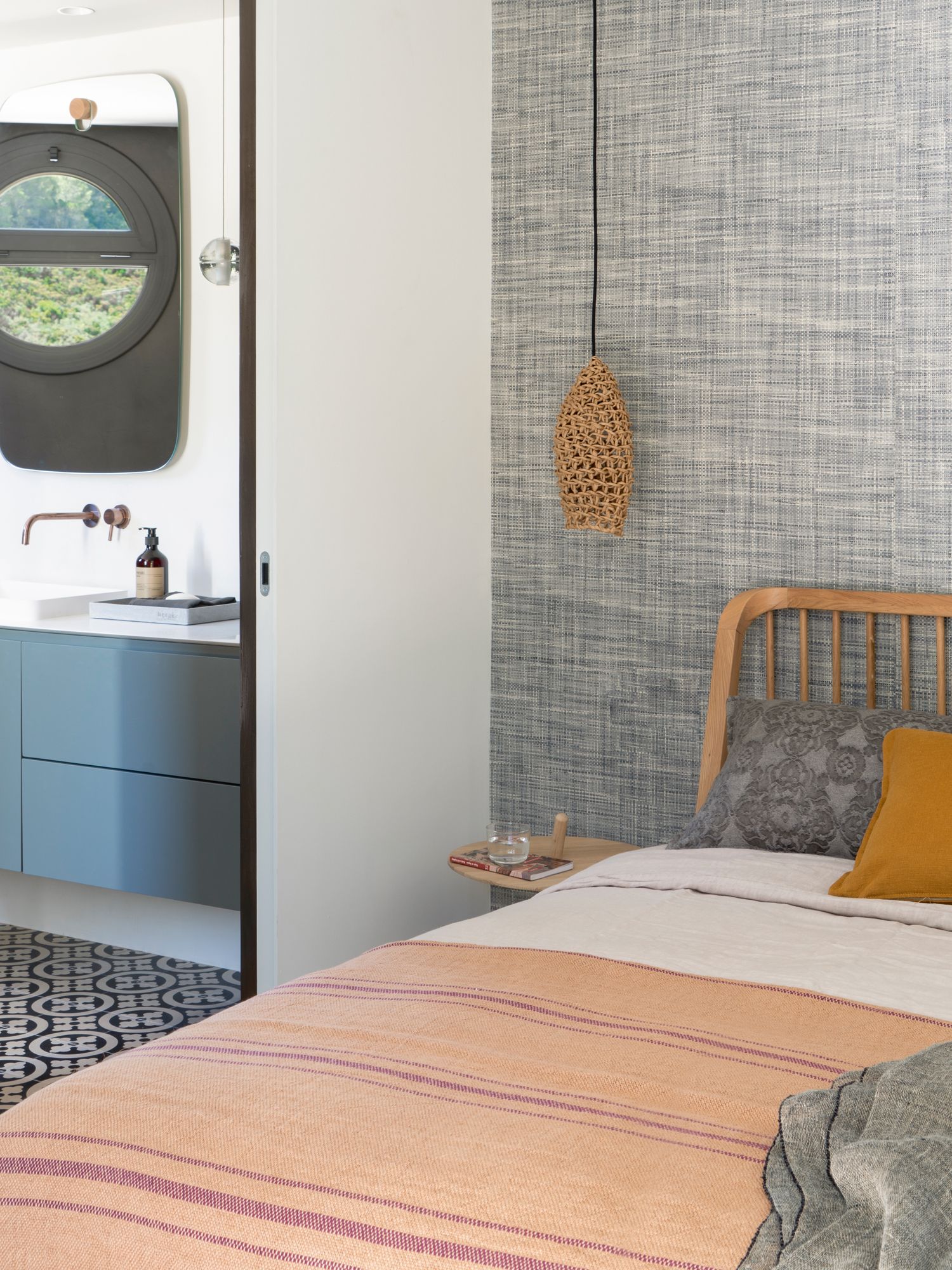 Textured wallpaper from Phillip Jeffries adds a cosy touch to this bedroom, which features a bed from Ethnicraft, Woud bedside table and a Best Before pendant lamp