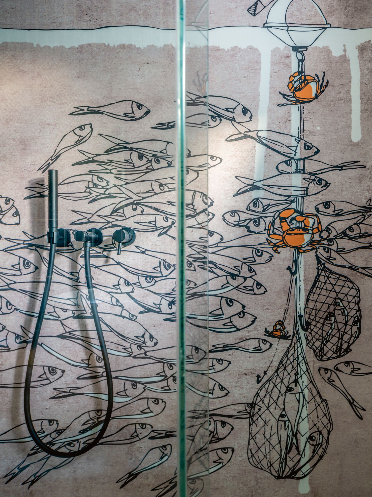 The marine mural in the bathroom continues the nautical influence of the home