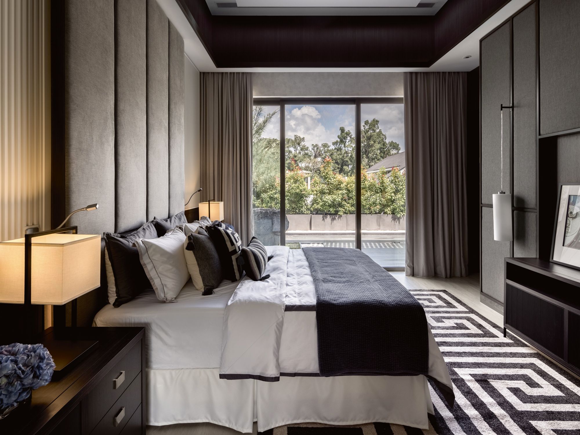 This geometric rug adds character to the monochromatic scheme of the master bedroom