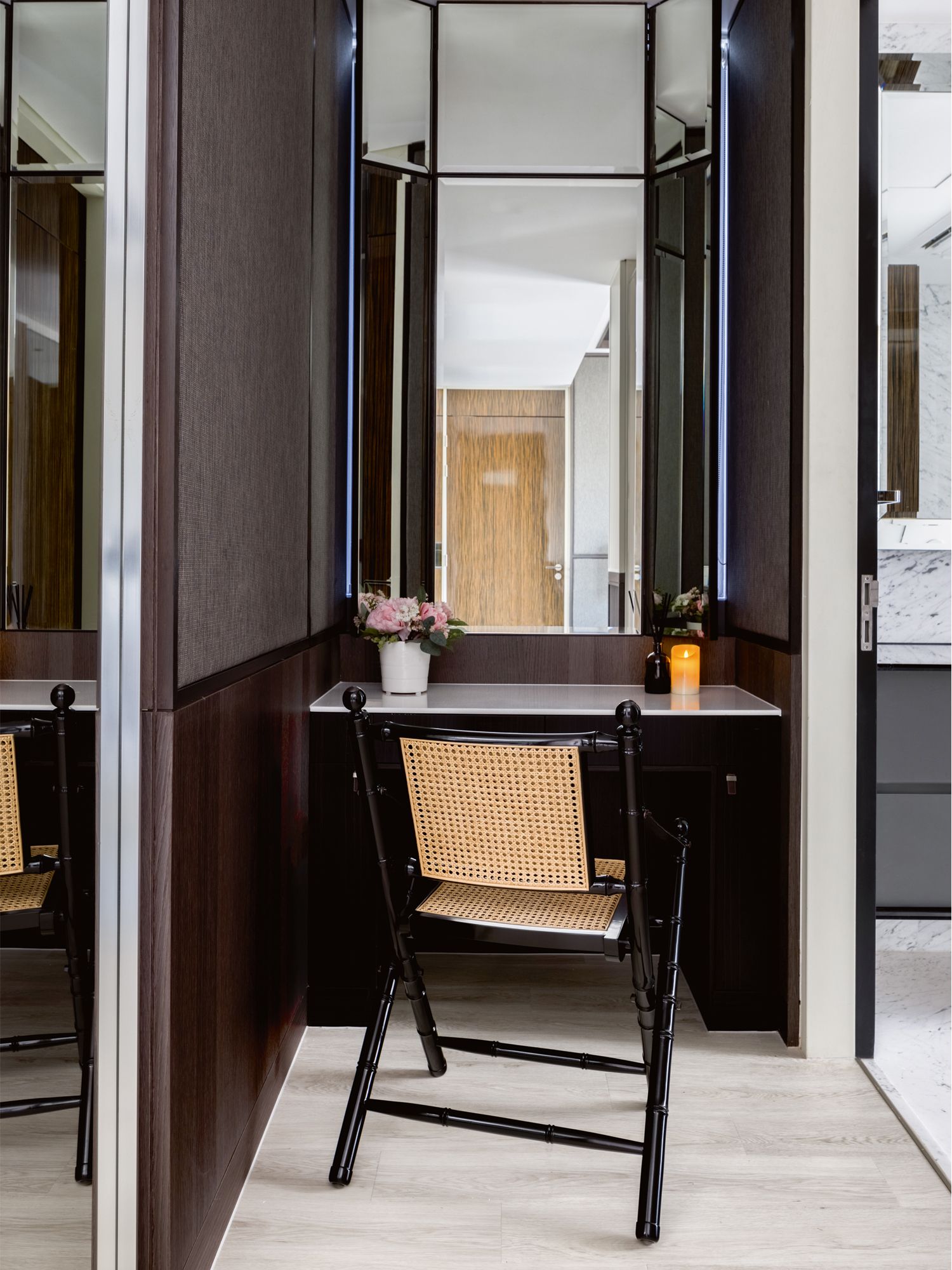 A rattan chair brings a tropical touch to this vanity area