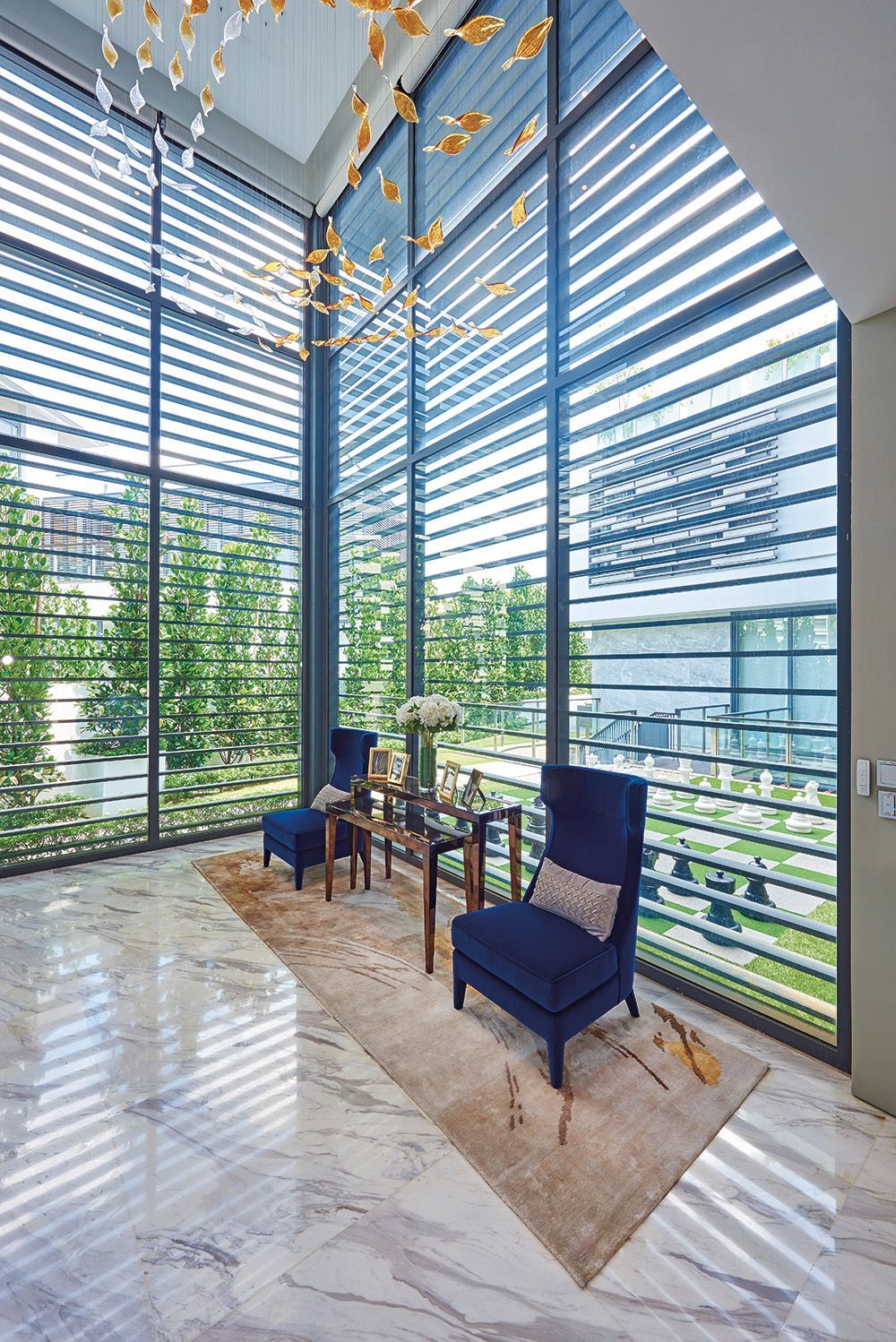 A bespoke crystal chandelier hangs in the entryway of this home, previously designed by Murray