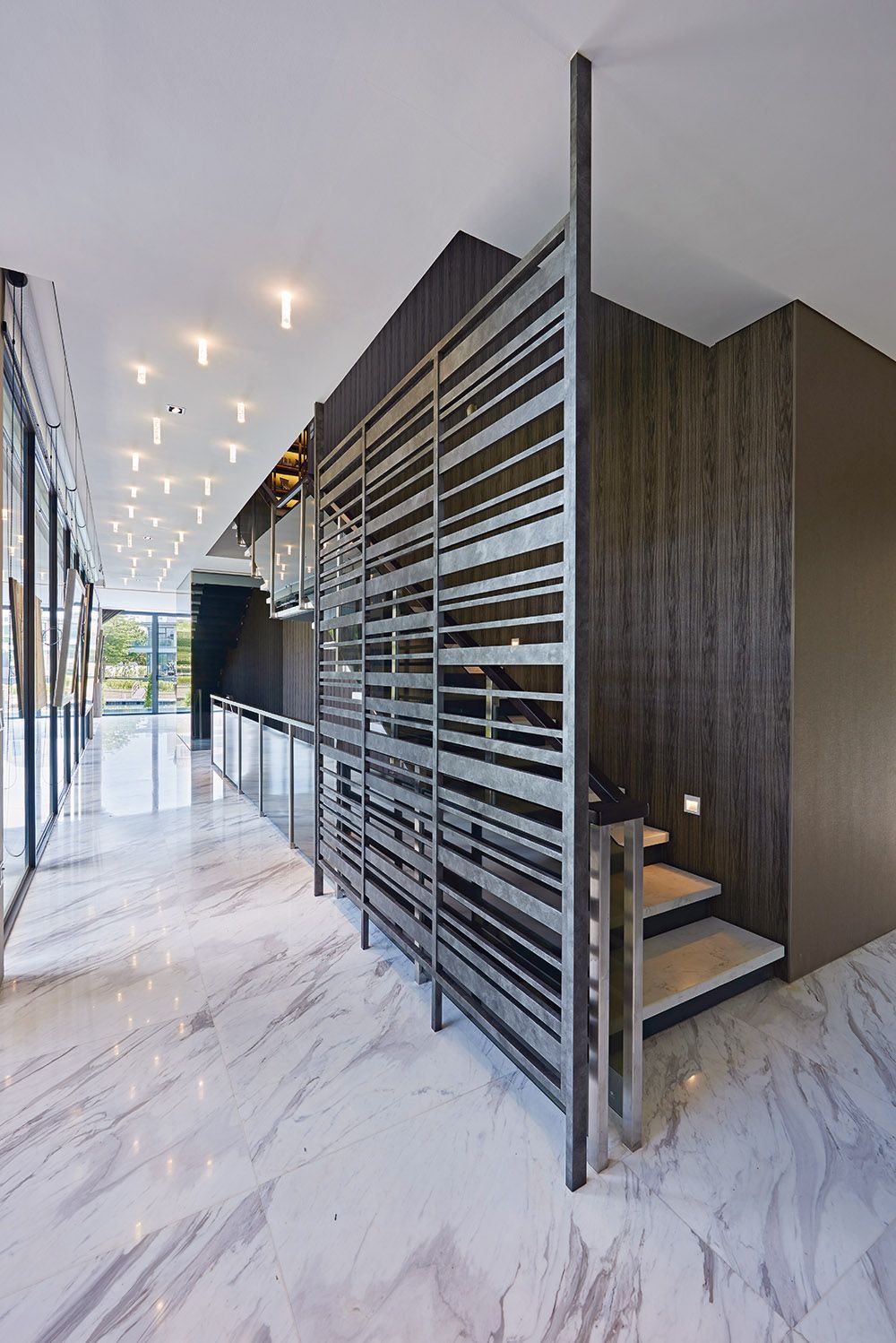 The marble flooring provides a textural contrast to the wooden details