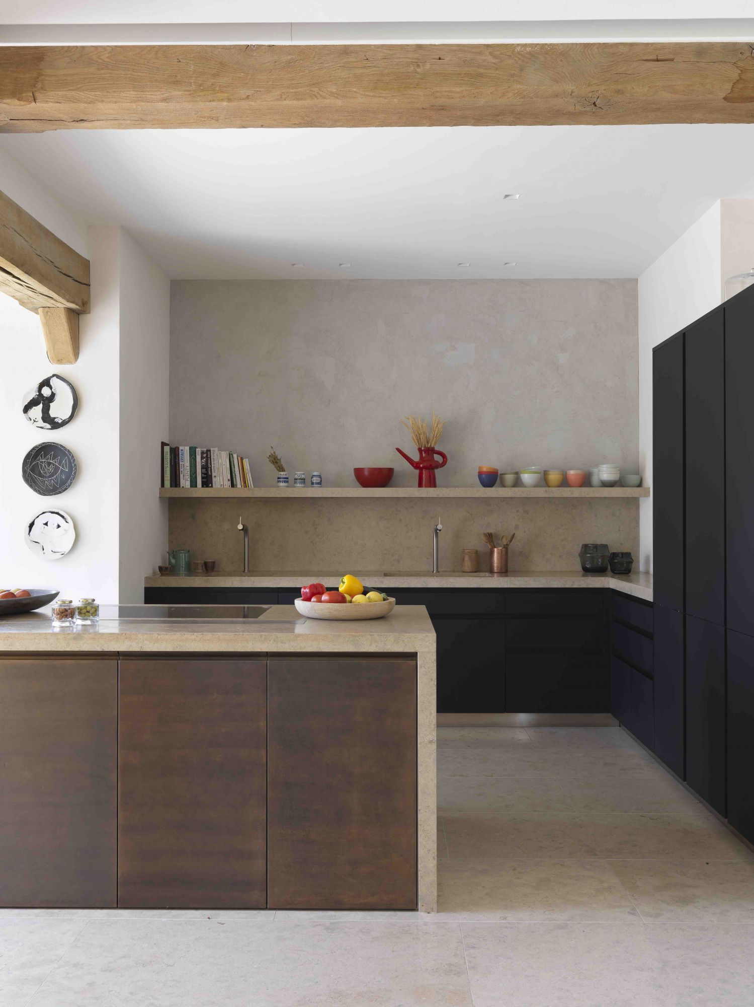 Designed by Jessica Barouch, this cosy kitchen showcases the prominent use of wood, stone and ceramics (Image: Stephan Julliard)