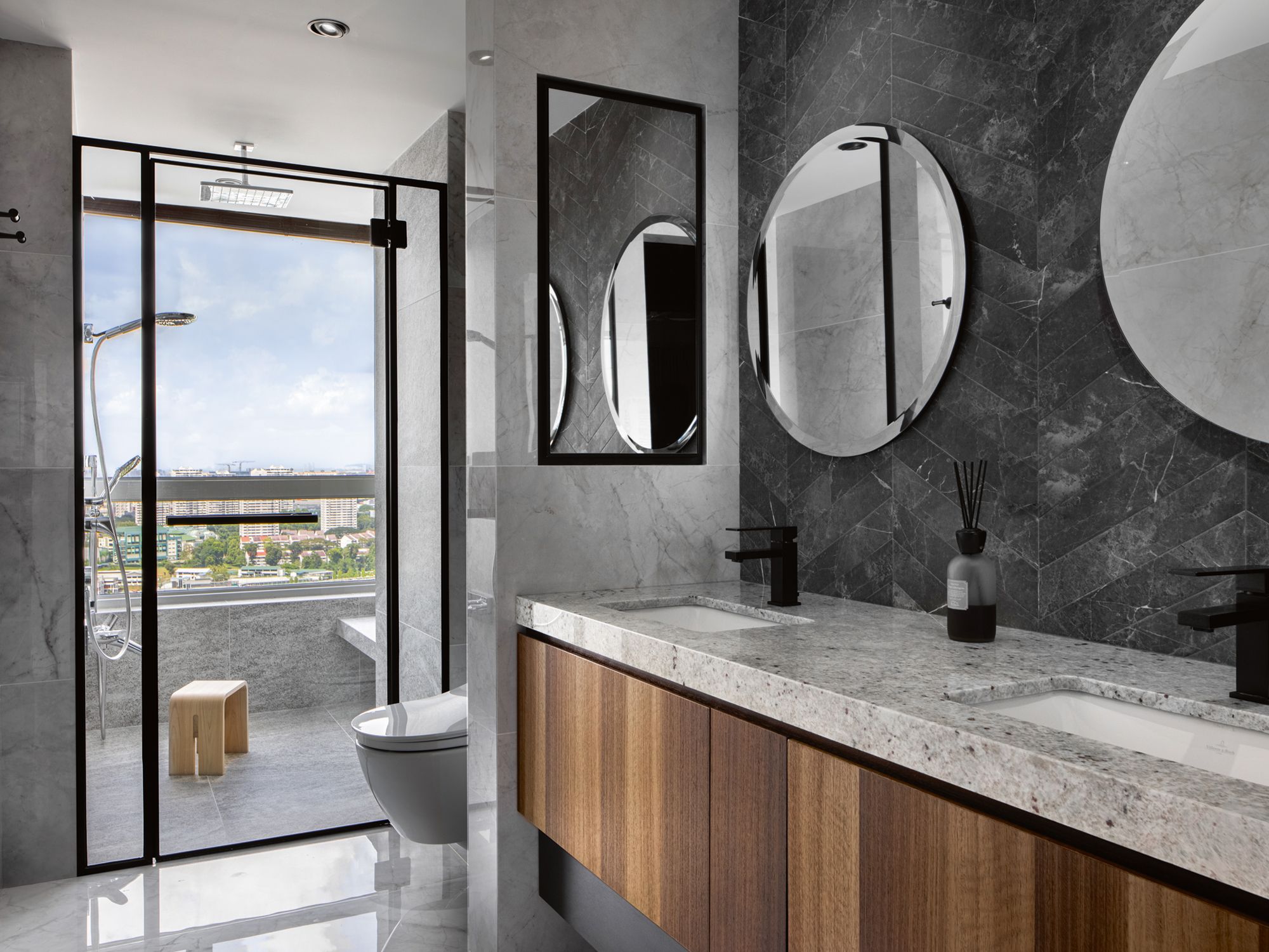 The full-height glass door amplifies the sense of space in the master bathroom