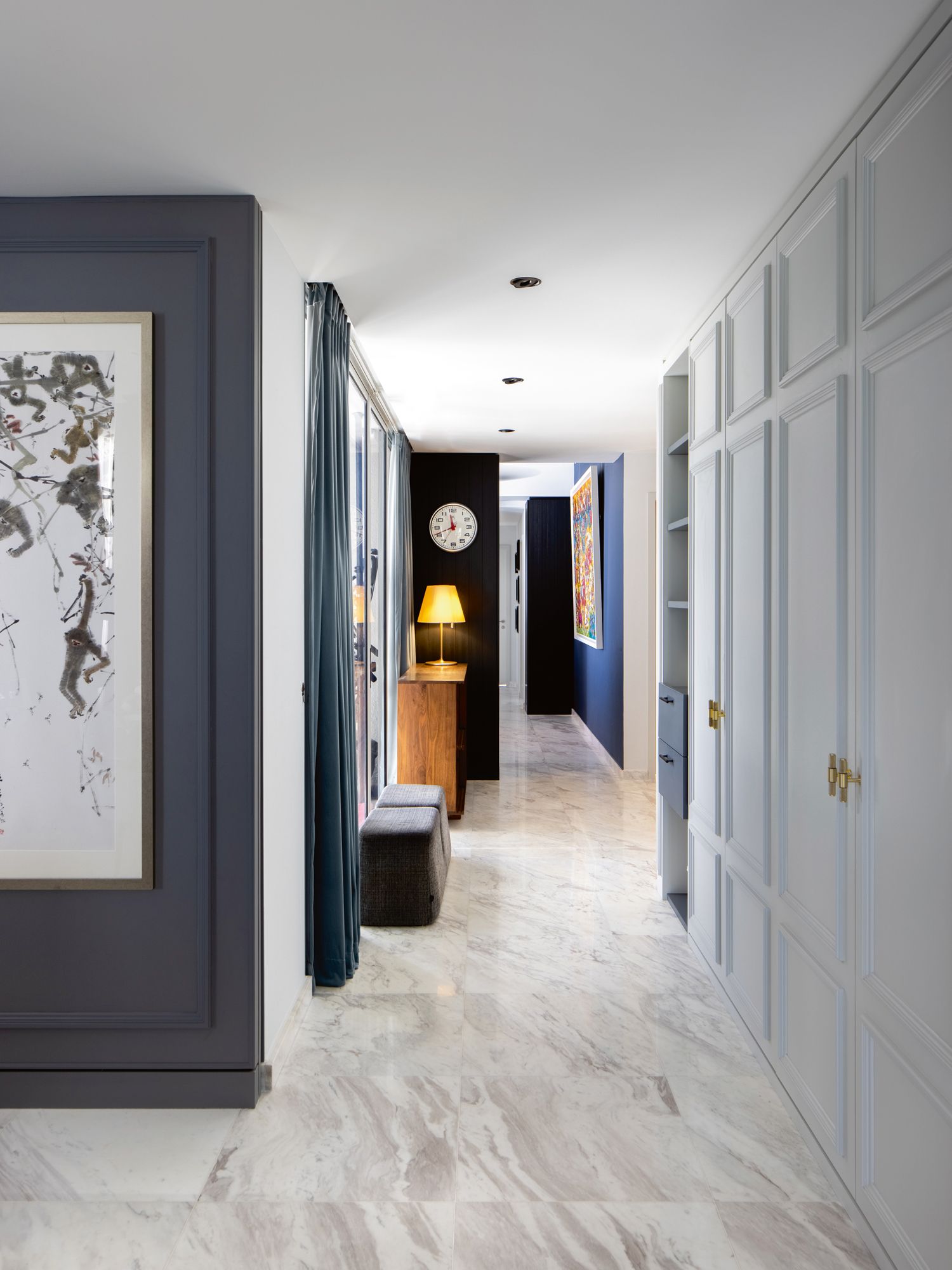 Colourful artworks and a decorative lamp liven up the corridor