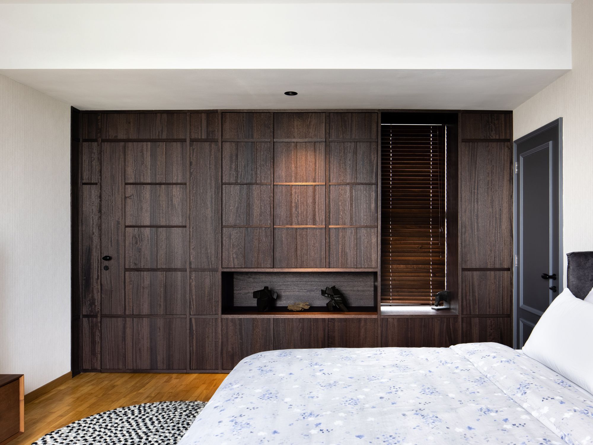 Dark cabinets contribute to the handsome look of the master bedroom
