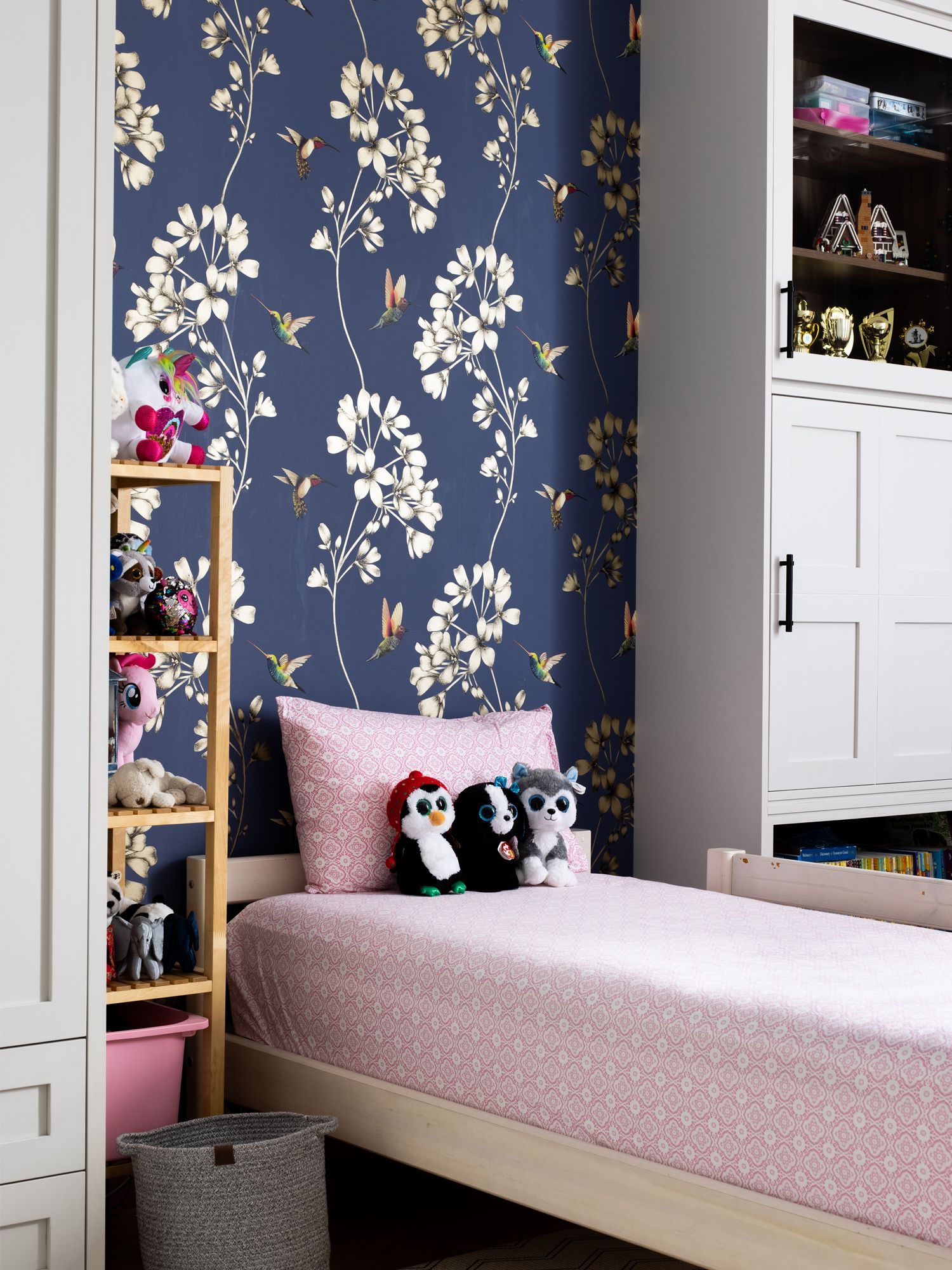 The daughter's bedroom features a decorative navy wallpaper with gold motifs