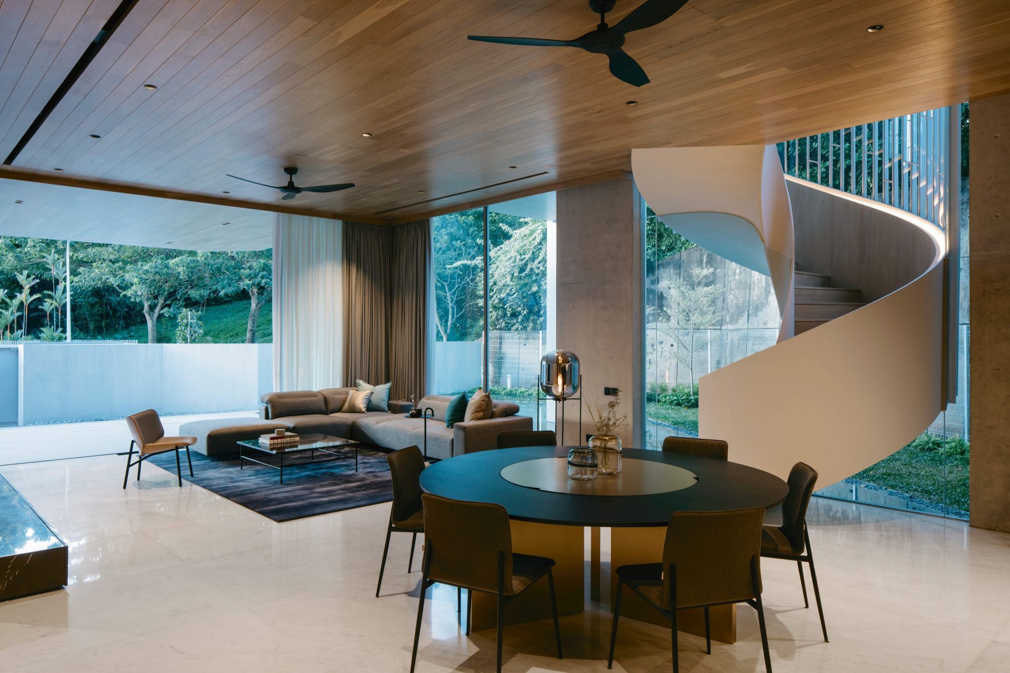 The curved staircase on the open-plan first storey of the house is a cosy invitation to the upper levels
