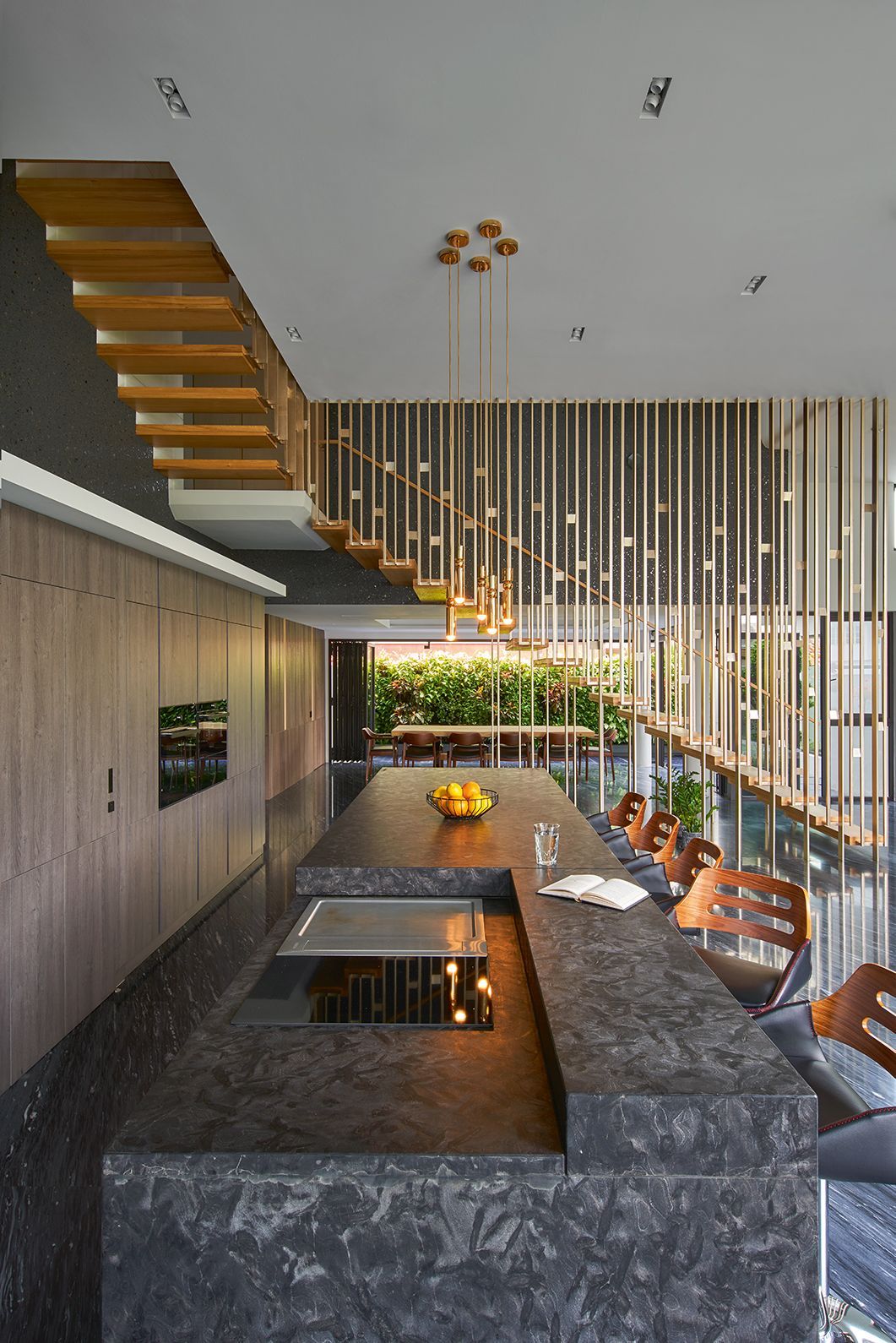 The stylish gold staircase makes for a dazzling visual statement from the kitchen (Photography: Jasper Yu)