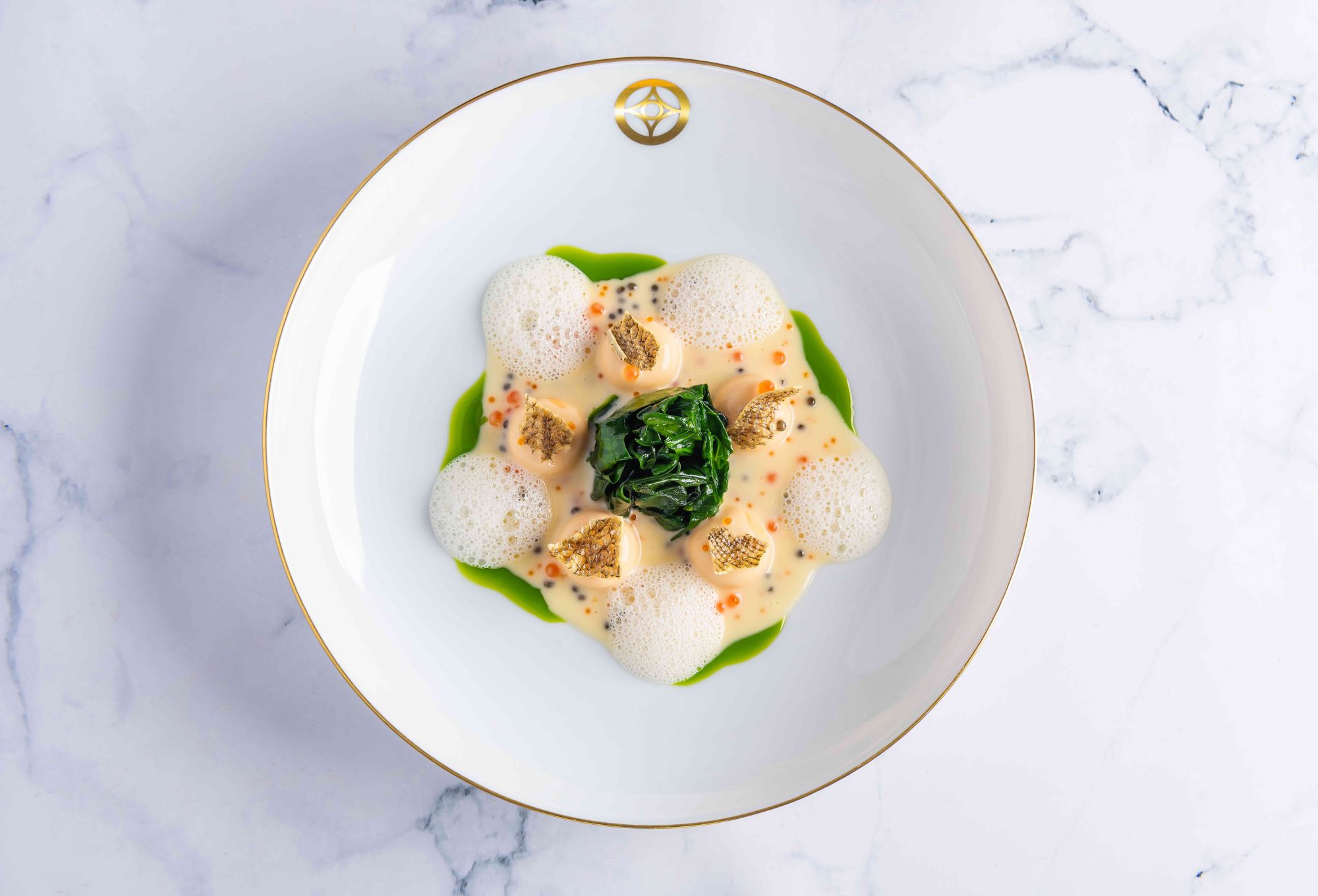 Salmon bonbons, butter sauce with fish eggs and caviar, chives oil