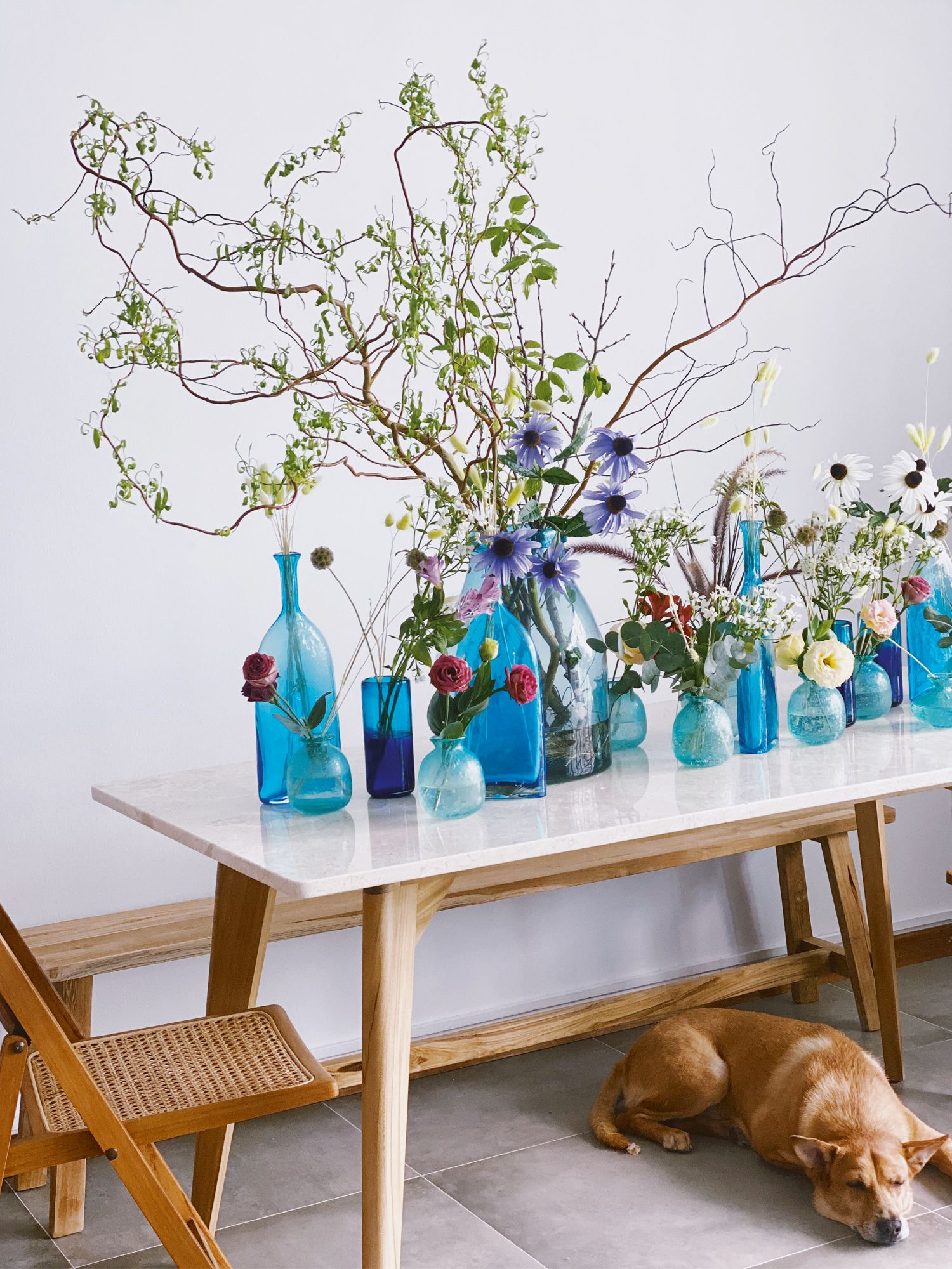 Studio Poppy creative director Sarah Lim uses blue vessels of different shapes and sizes to create a layered effect