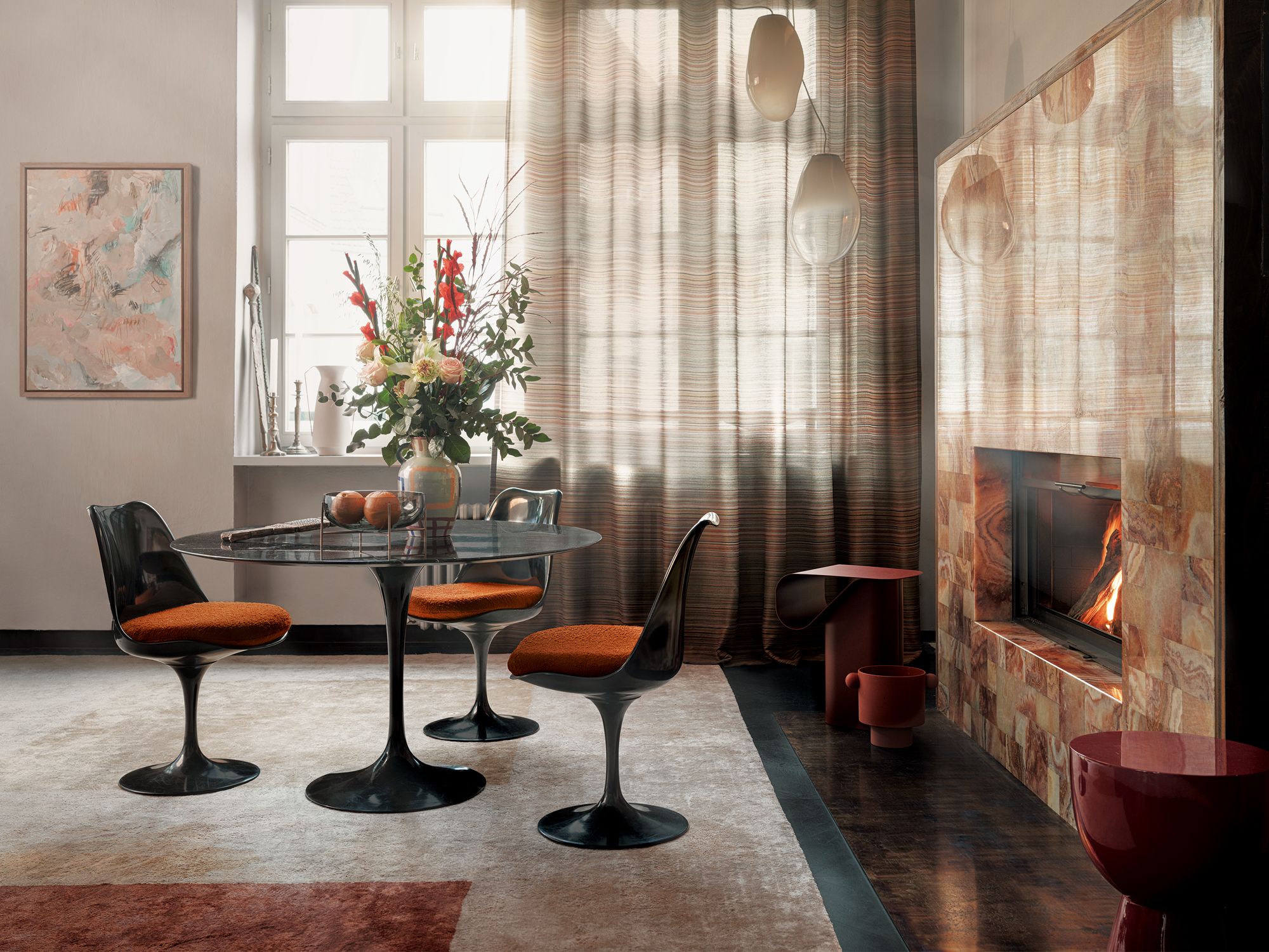 The orange tones of the bouquet echo the rich russet hues of the Zimmer+Rohde Canyon upholstery fabric from Cetec, used here on the chairs