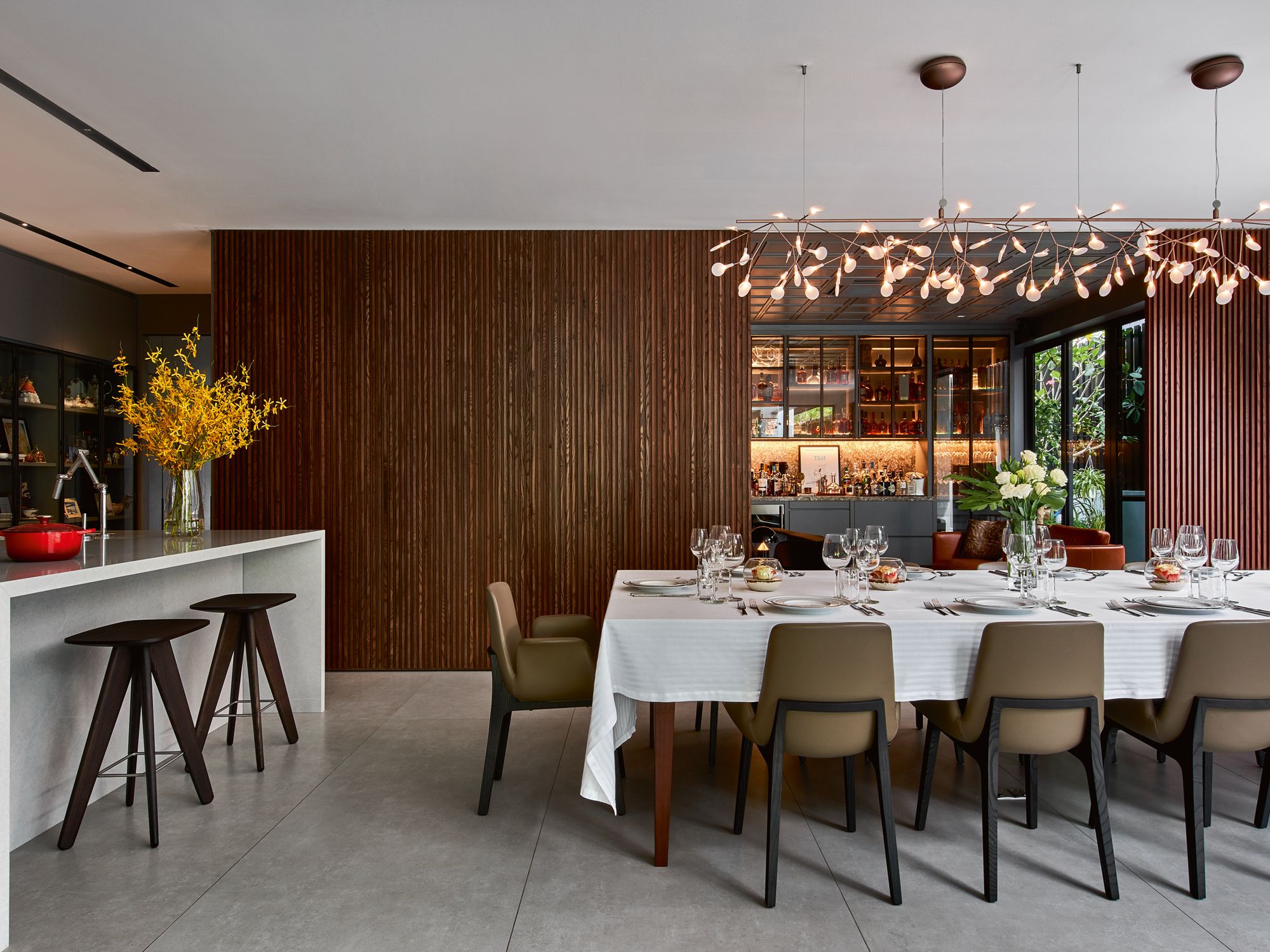 The Moooi Heracleum II pendant light creates a focal point in the dining area, drawing the eye towards the drinking lounge at the back