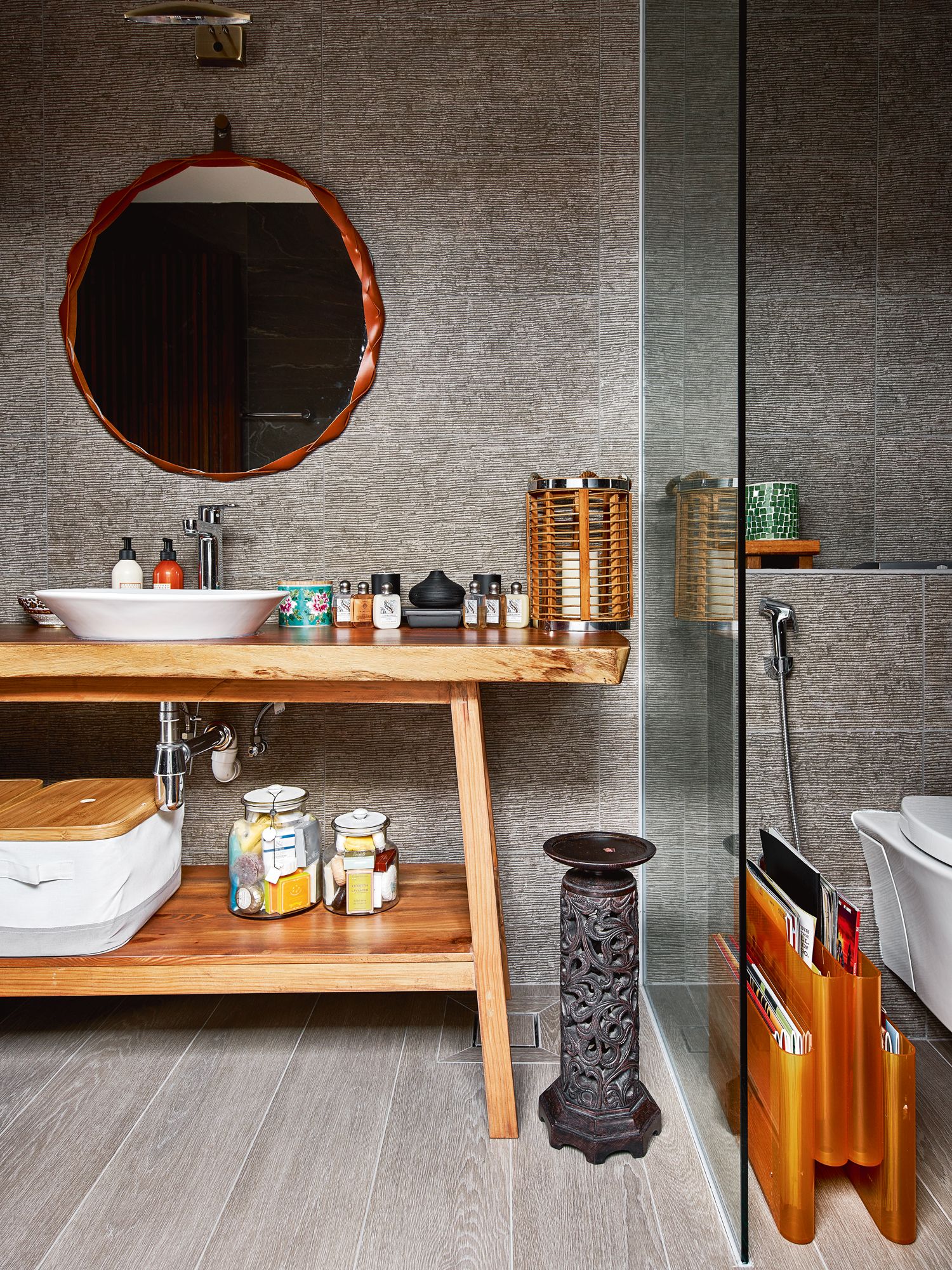 The timber-themed powder room next to the home gym features a tropical look