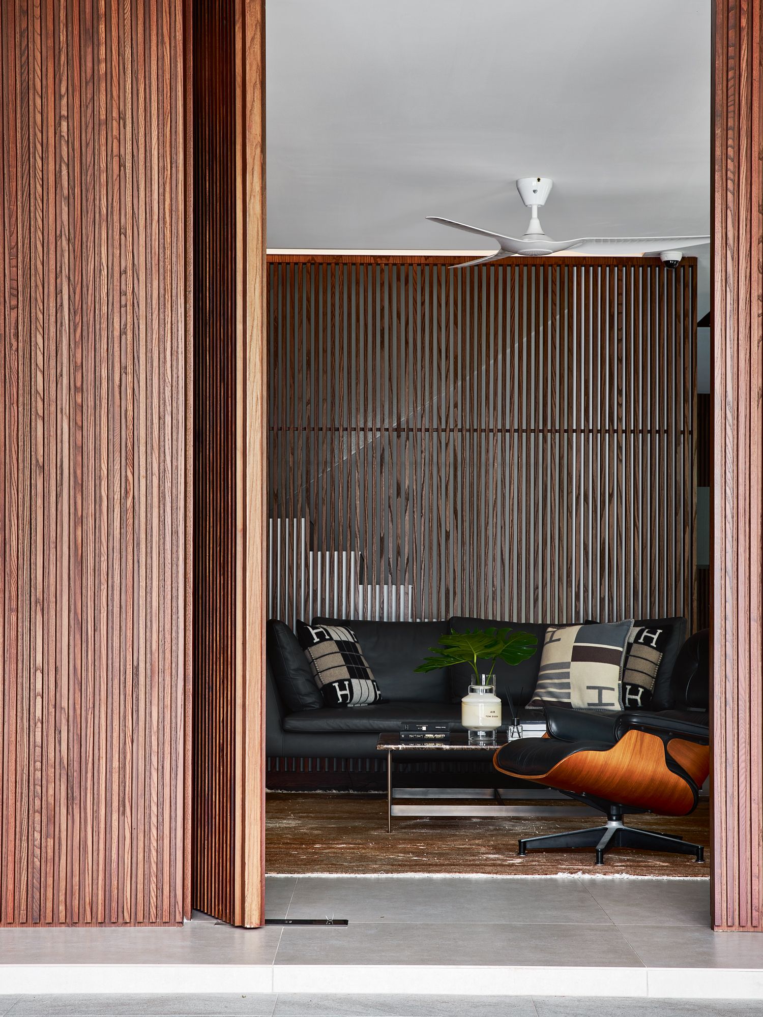 These vertical slats in a walnut-stained ash veneer are among the home’s defining features