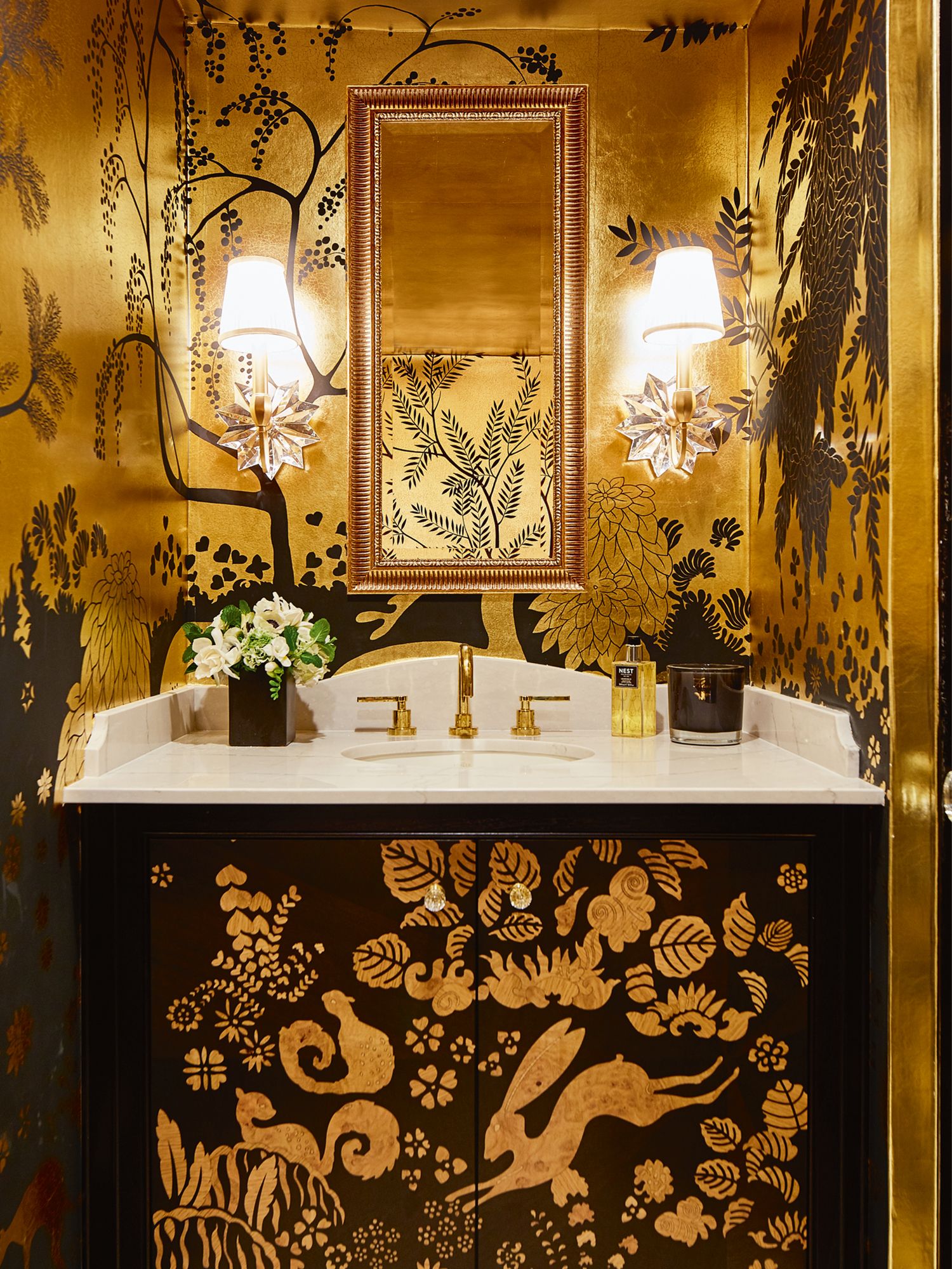 De Gournay Rateau wallpaper transforms this powder room into a glamorous space
