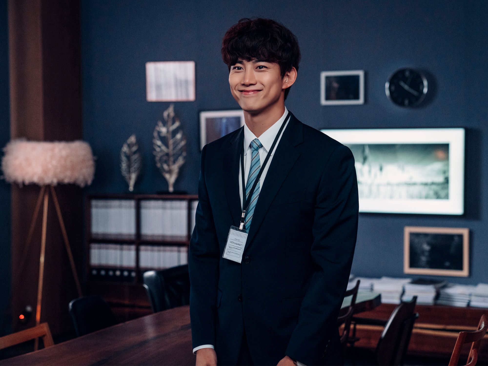 Jang Joon-woo in Hong Cha-young's office, decorated with dark blue tones and timber details (Image: Netflix)