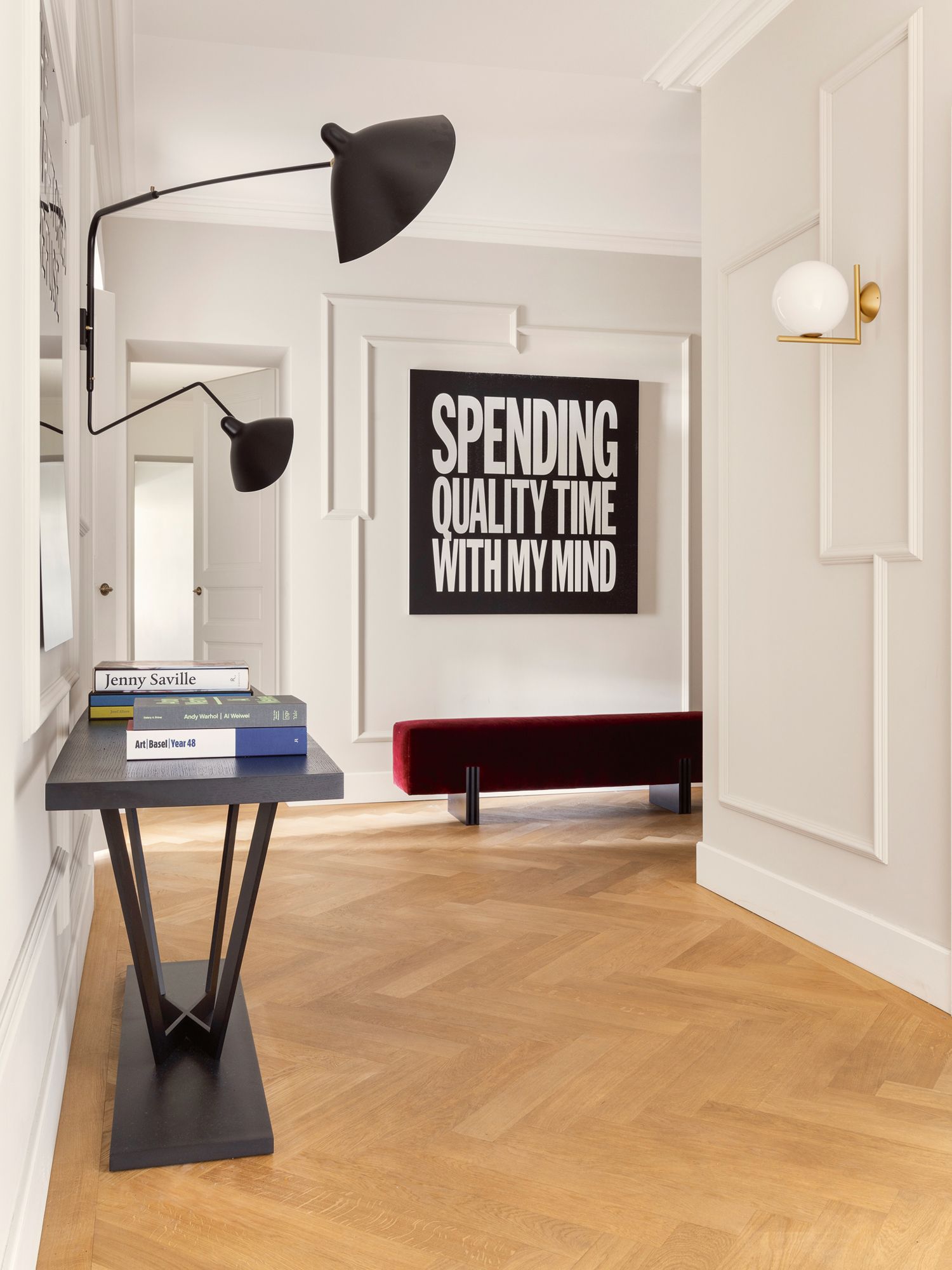 The hall features an artwork by John Giorno, Apua bench by Bruno Moinard Éditions, Rue du Louvre console from Avenue Road and a wall light by Serge Mouille from the fifties