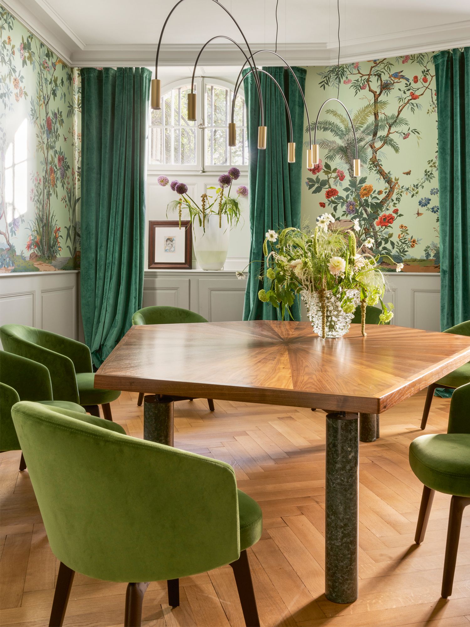 The dining room features handmade wallpaper designed specially for the project by Zuber & Cie, as well as the Minotti Amélie dining chairs, a Volta suspension lamp from Estiluz and a custom dining table designed by Jaime Beriestain Studio