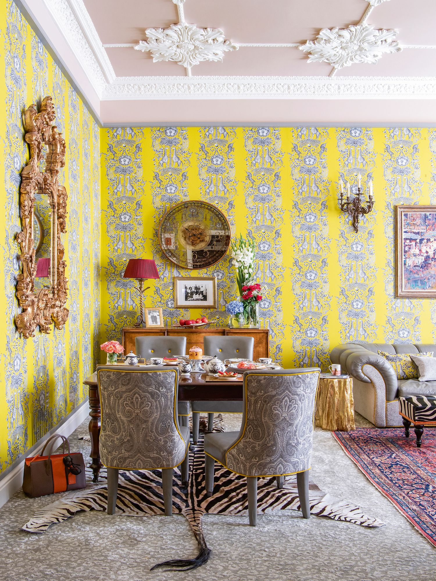 Set against a blush pink ceiling, the rococo-style plasterwork is an exquisite touch that brings attention to the full height of this home in London