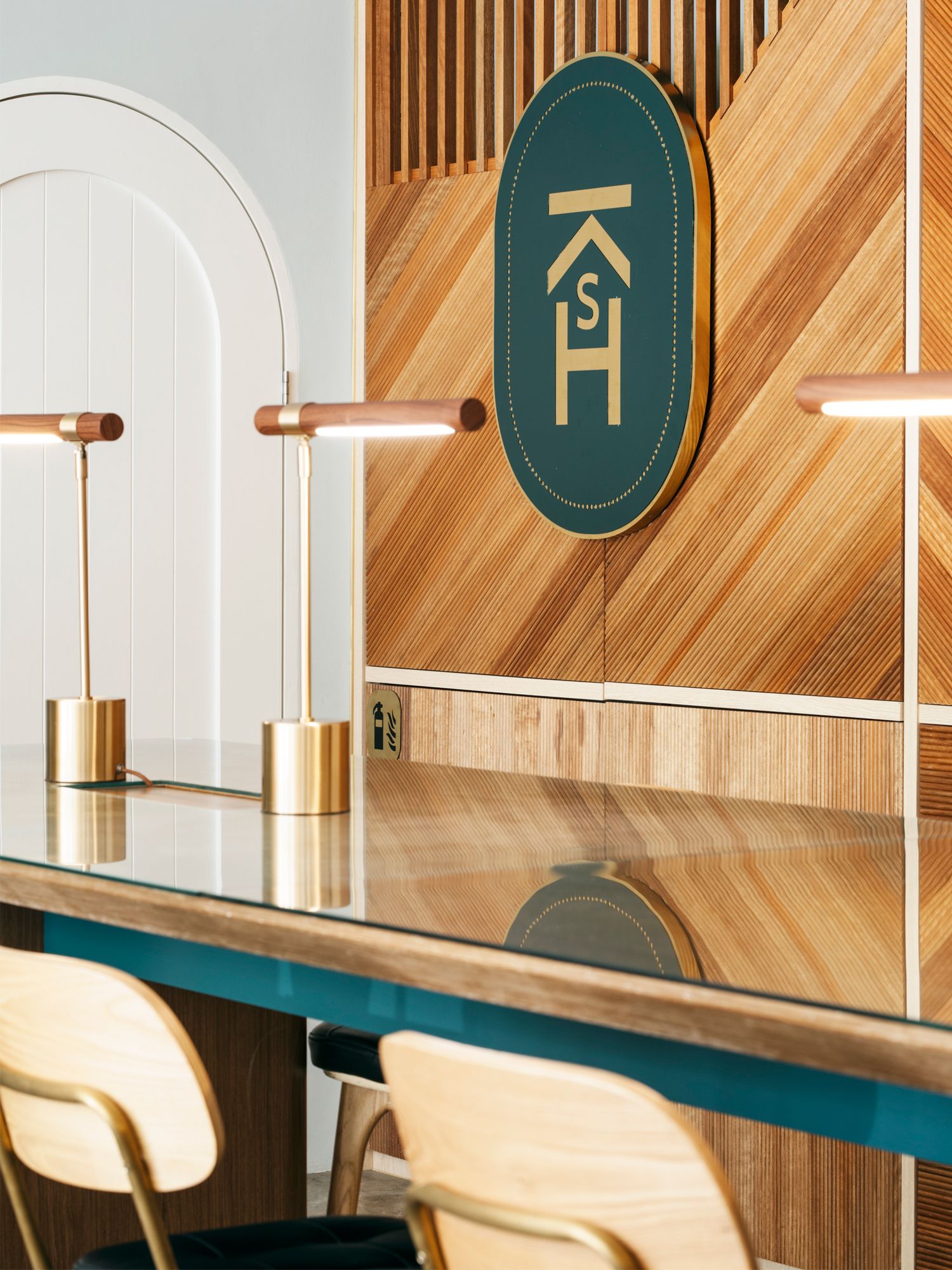 Green accents and light wood panelling create a chic and tasteful reception area