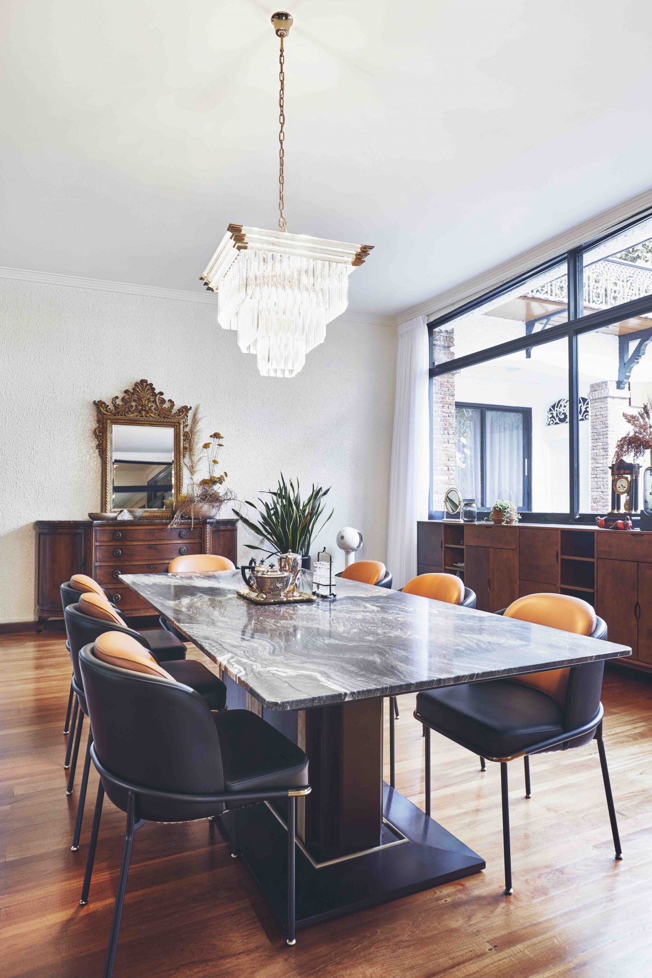 The home features the couple's extensive artistic vintage collection, such as this chandelier above the dining table