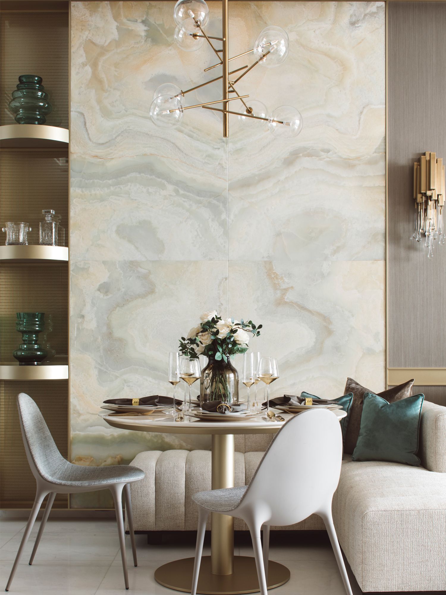 The bookmatched onyx marble slab in the living room adds a luxurious appeal to the space