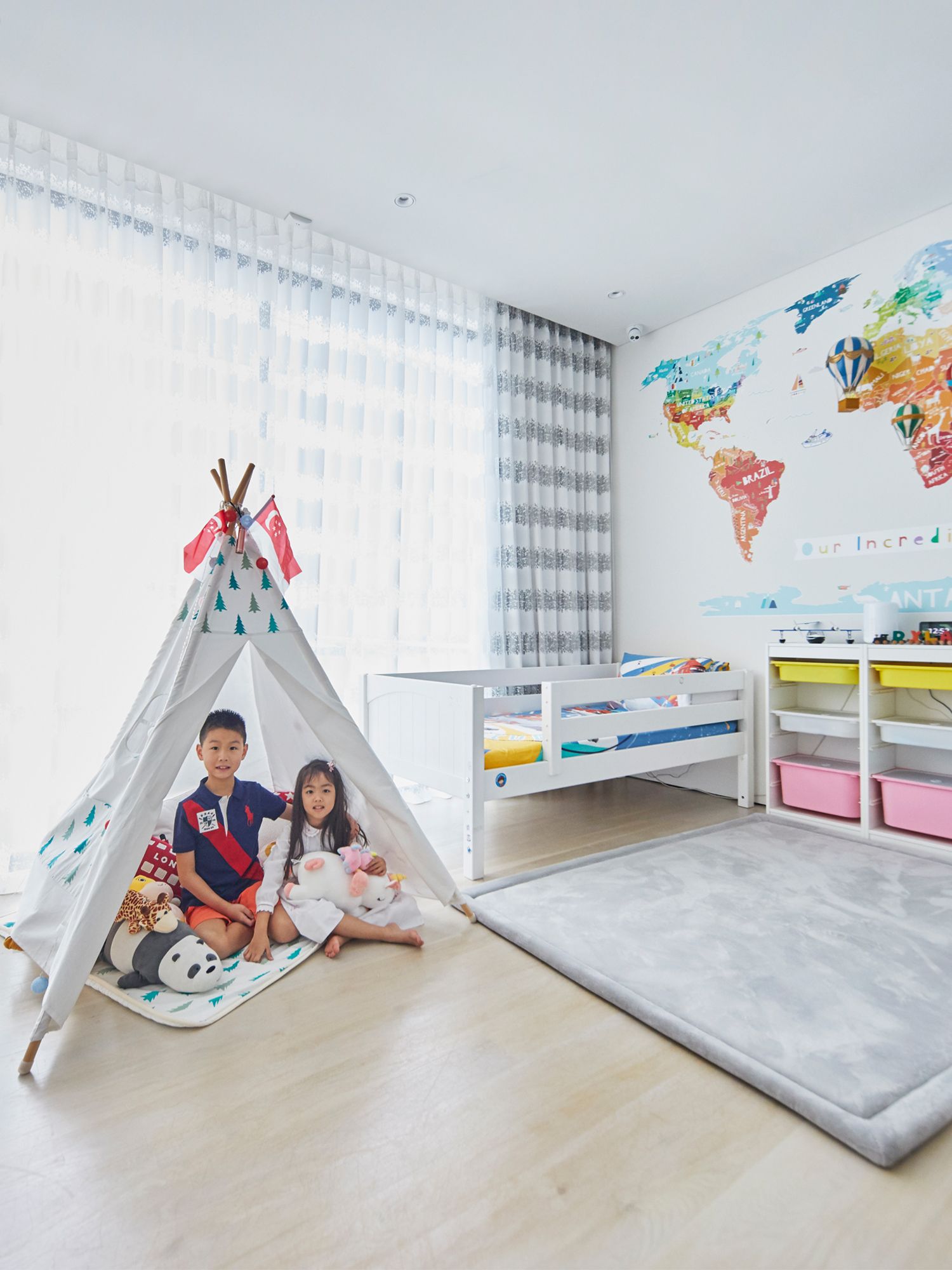 The children in the travel-themed bedroom