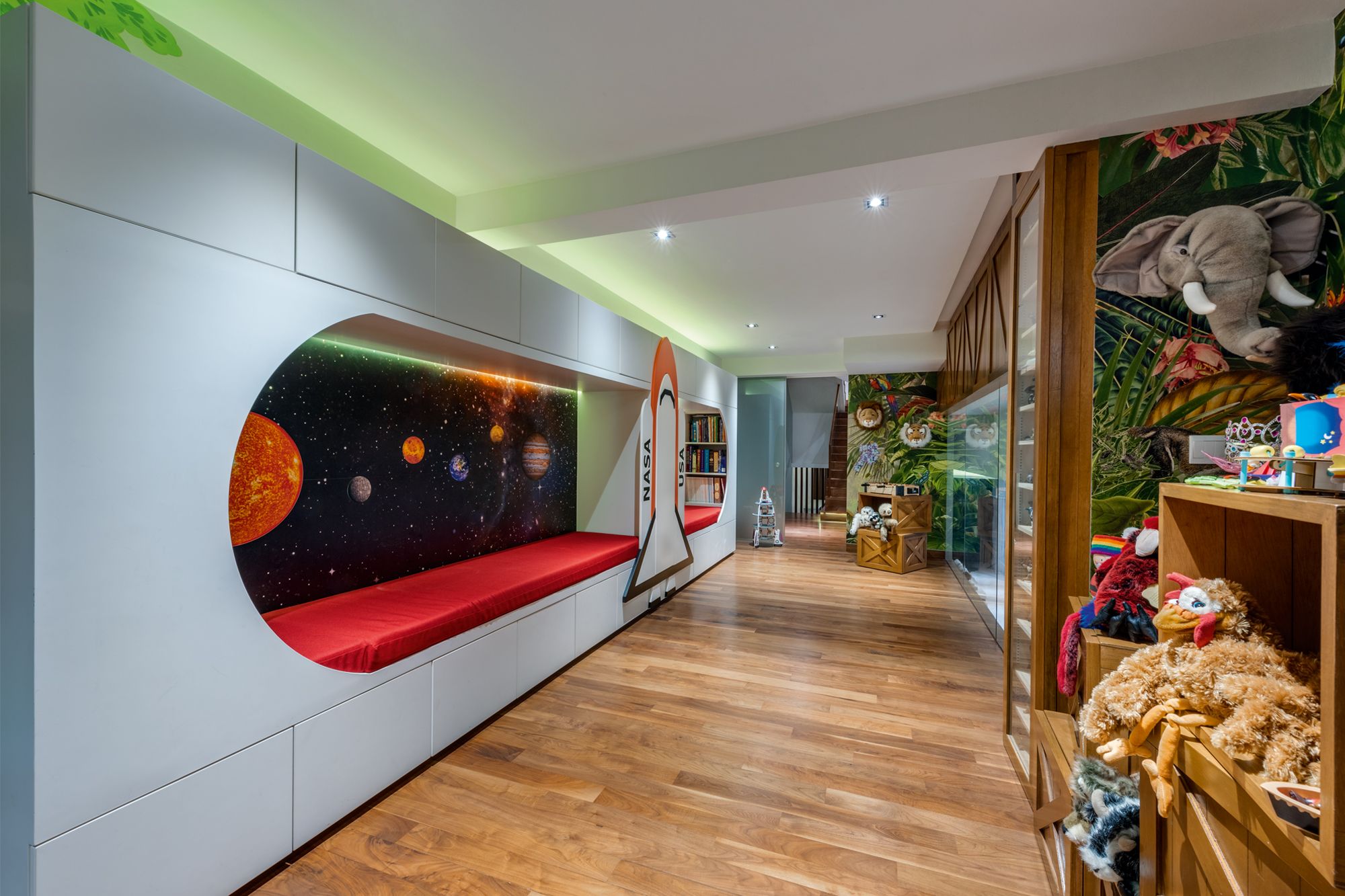 The children’s playroom features vibrant wallpaper and fun furnishings