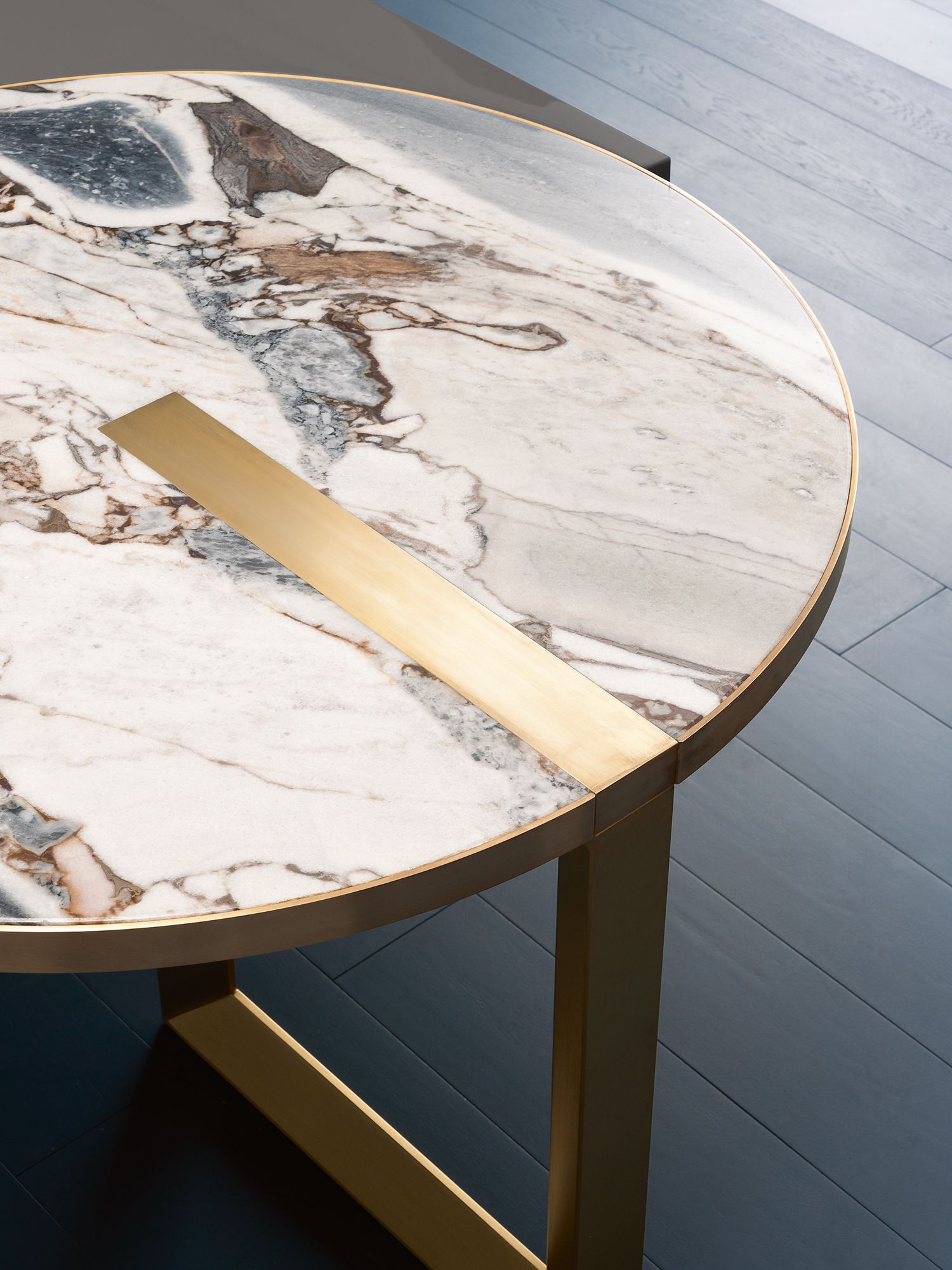 A close-up of the Selene table by Hagit Pincovici in glossy ocean storm marble