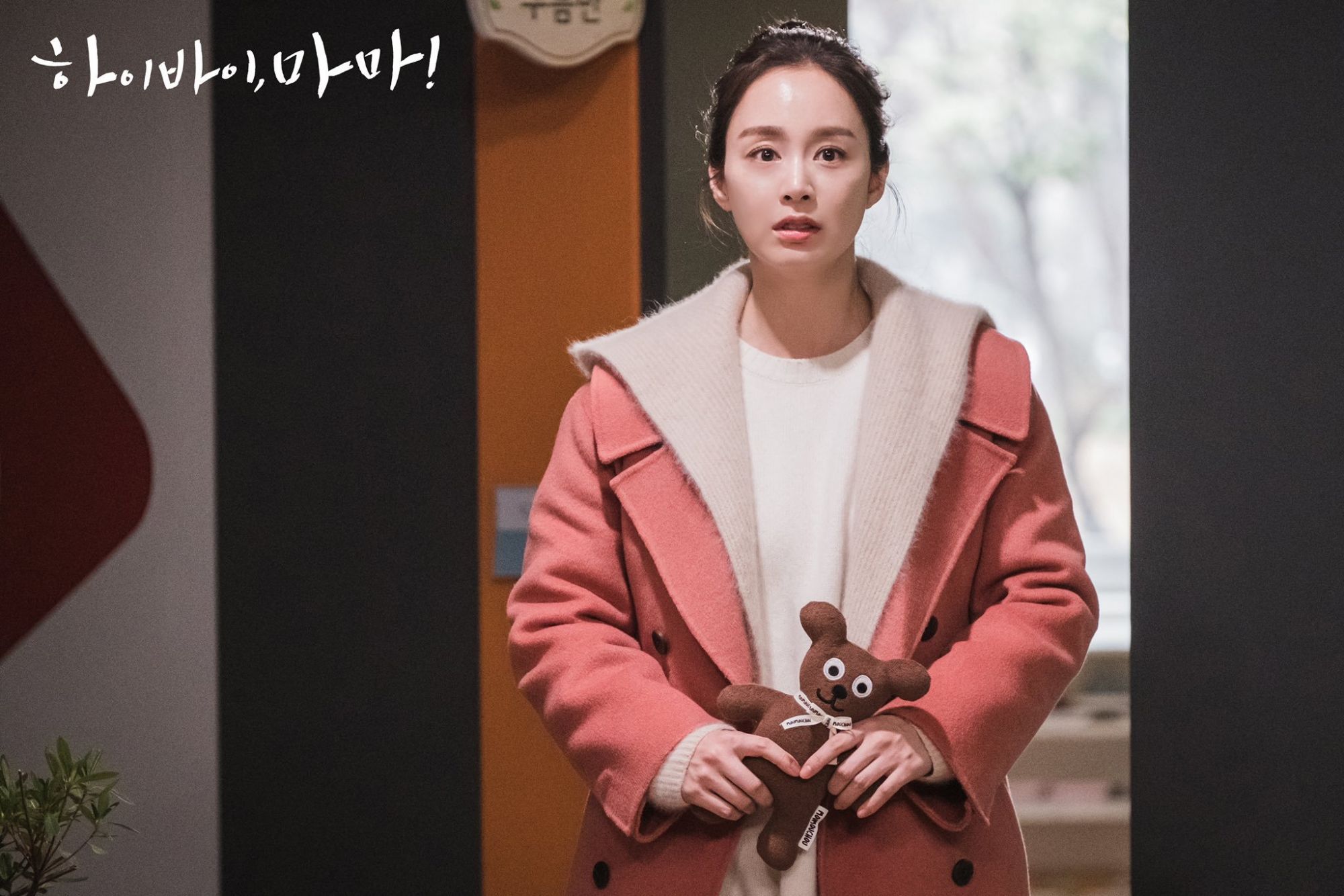 Another promo still for <i>Hi Bye, Mama!</i>, this time in a long hooded cardigan from Jigott layered with an On & On cashmere handmade coat. Photo: Netflix