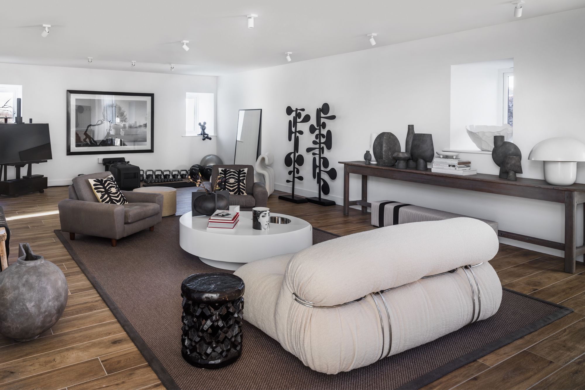 The entertainment area and private gym space is stylishly designed with a mix of contemporary and rustic furnishings
