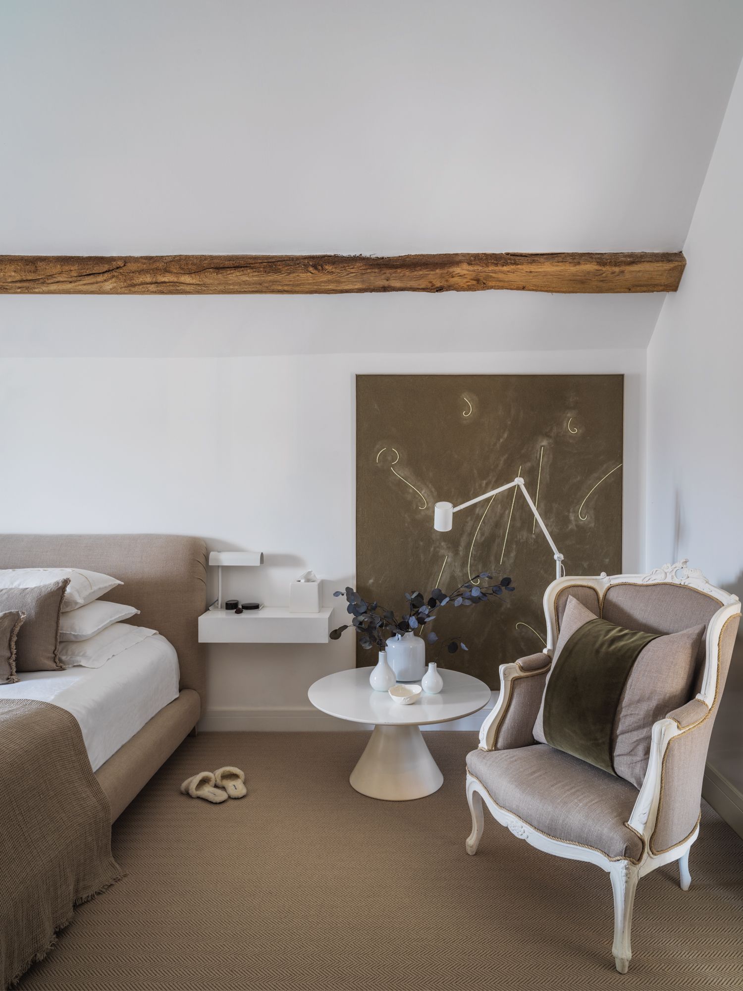 In the bedroom, ceramic vessels accentuate a vintage table by Arkana from Vinterior