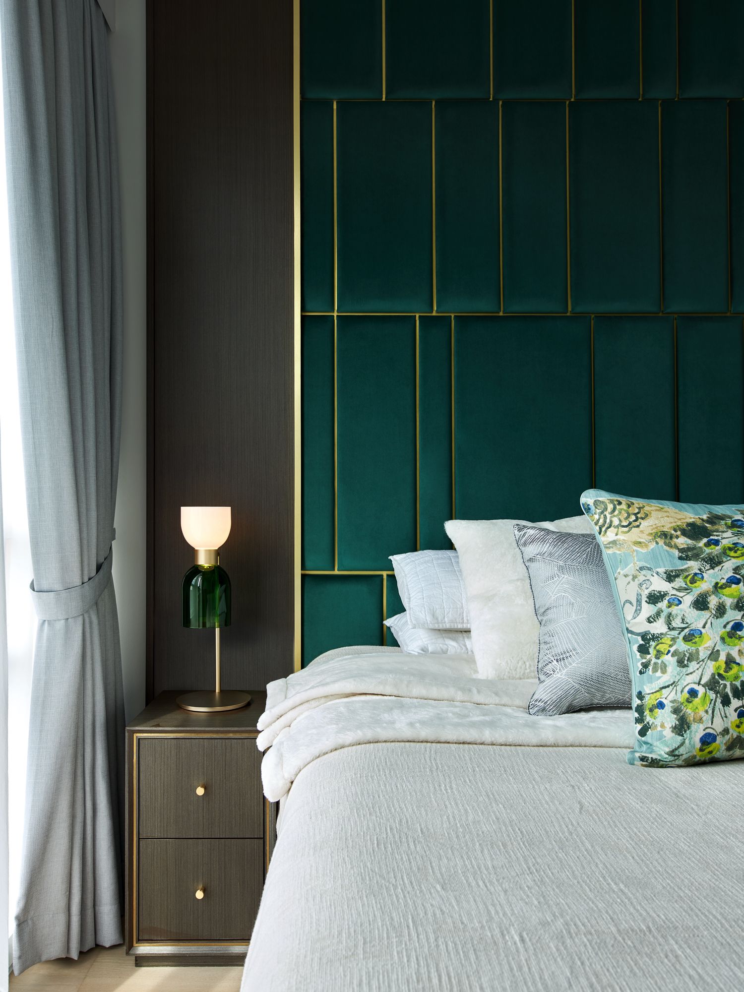 Emerald velvet panels contribute to the cocooning feel of the master bedroom