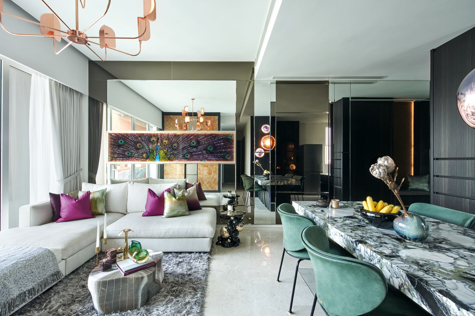Purple and fern-green tones on the accent cushions, and a peacock artwork contribute to the lively look of the open-plan living and dining areas