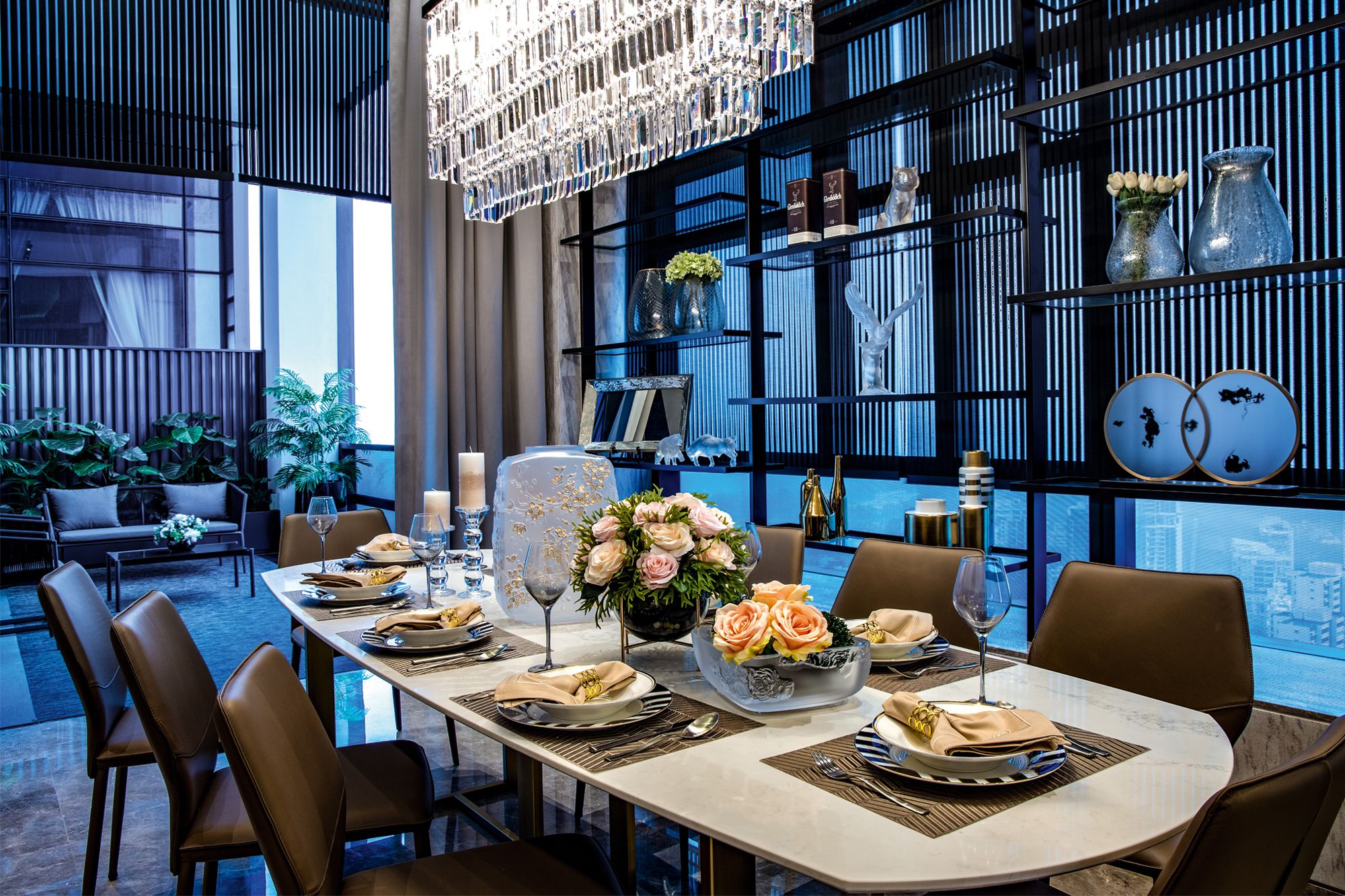 Shelves decorated with objets d’art act as an elegant backdrop for the eight-seater dining table