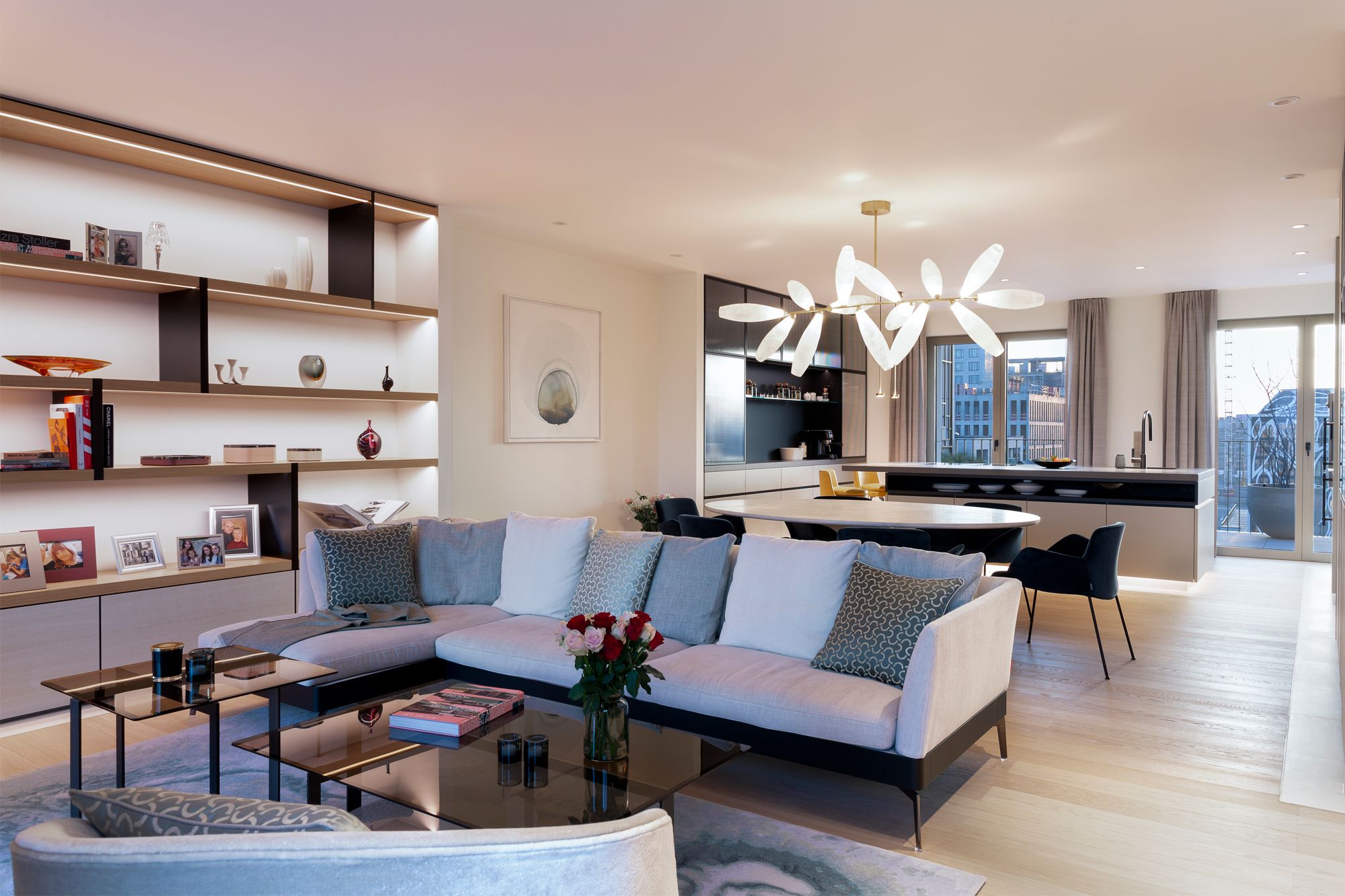 The open-plan living area seamlessly connects to the dining and kitchen area, creating a bright and airy space