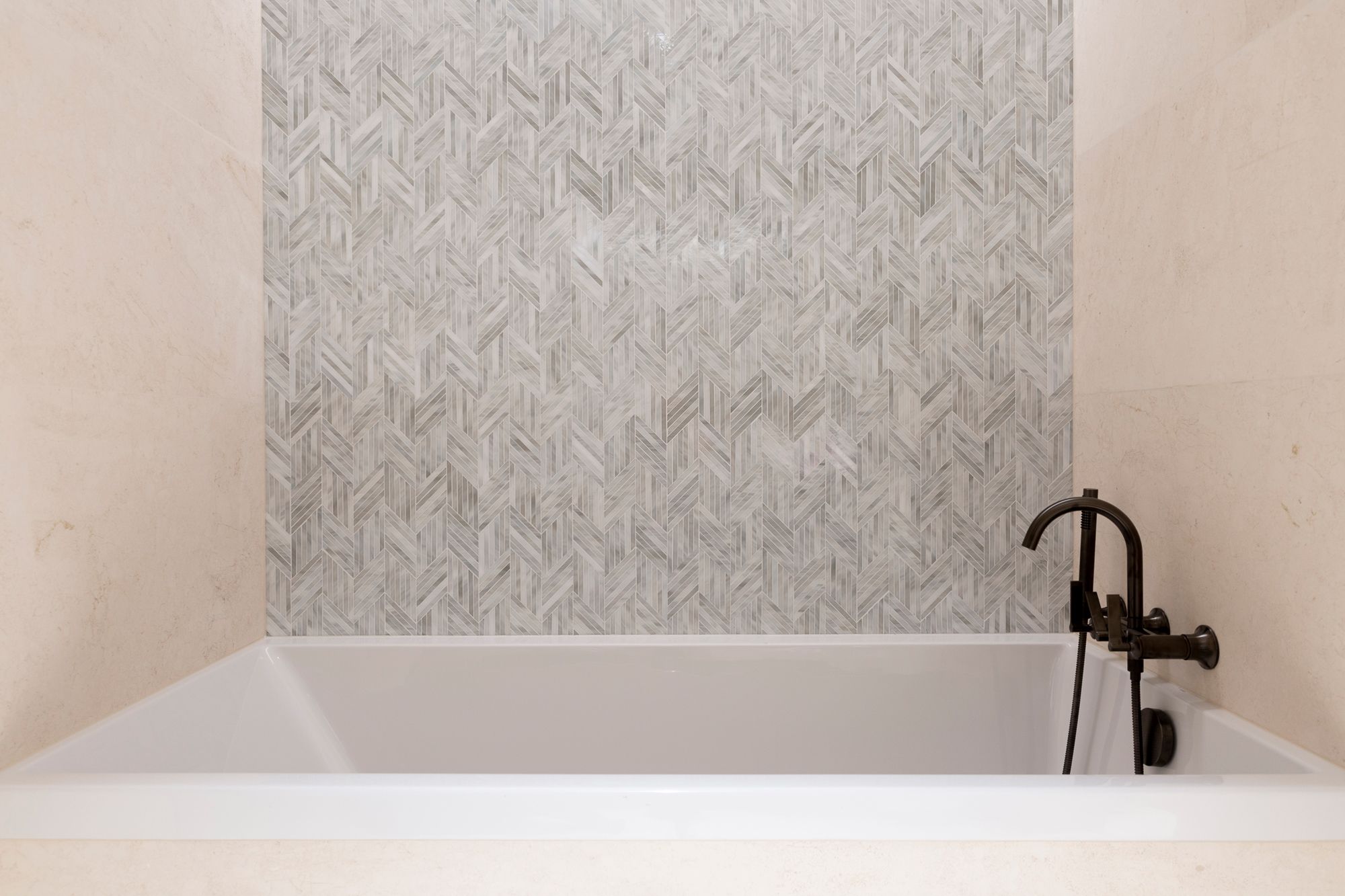 Lume tiles by Ann Sacks add a decorative touch to the bathrooms