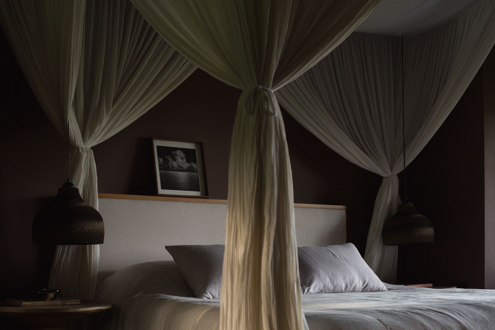 The master bedroom features a king-sized bed with a generously-sized mosquito net