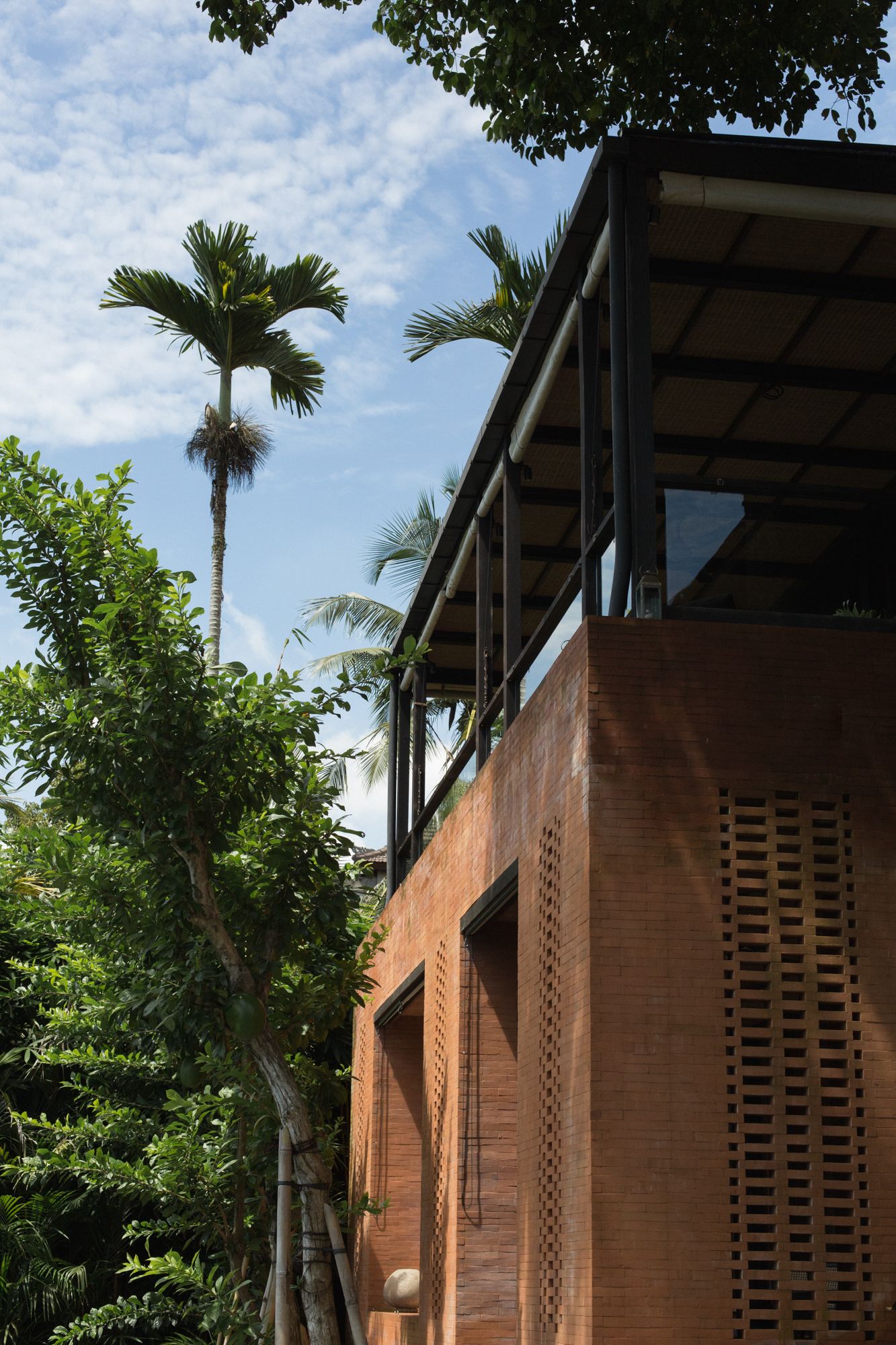 The exterior is made up of Balinese terracotta brick for the ground level and charred ironwood for the upper level