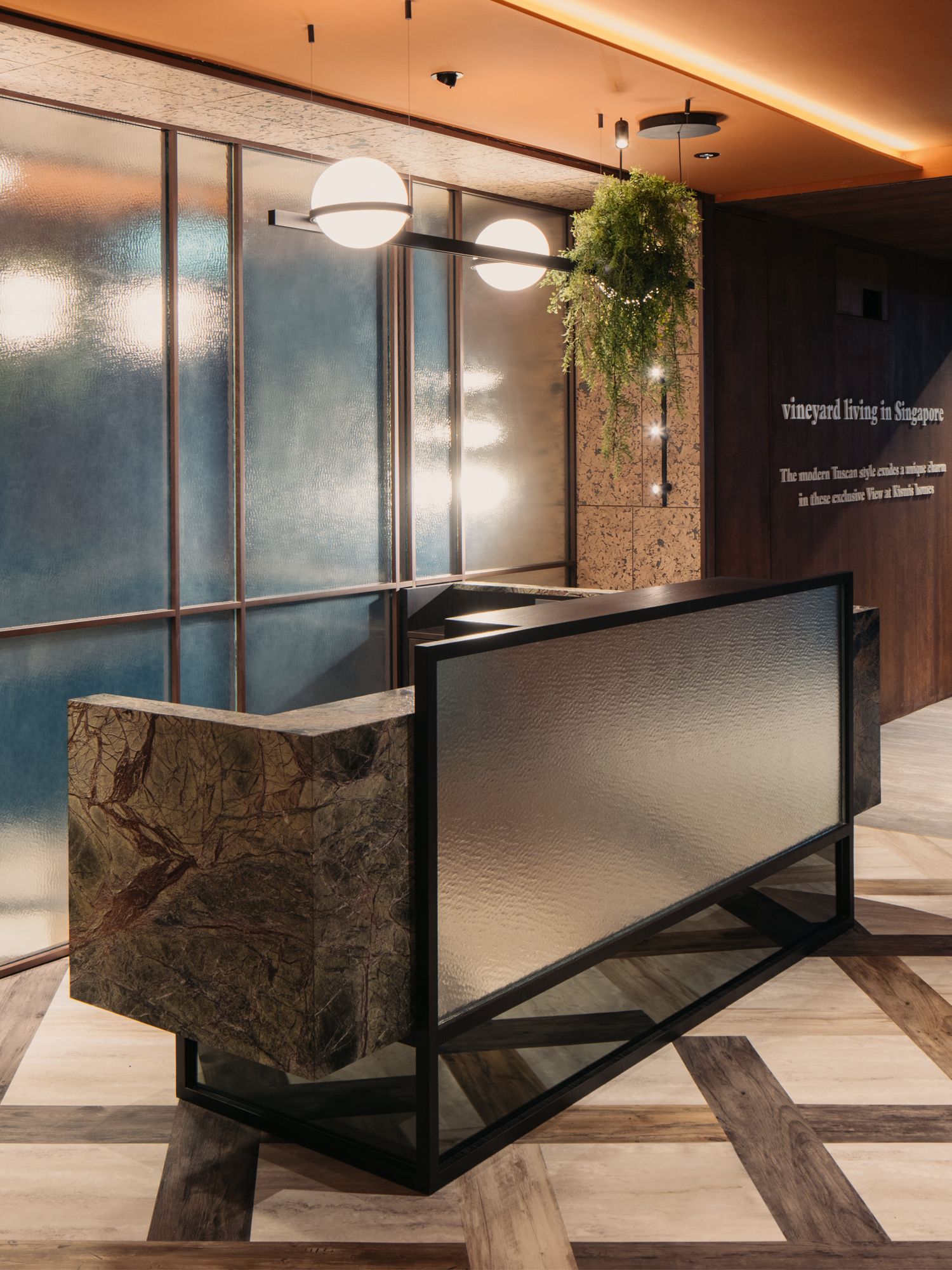 The angular form of the reception counter echoes the lines of the glass screens behind it