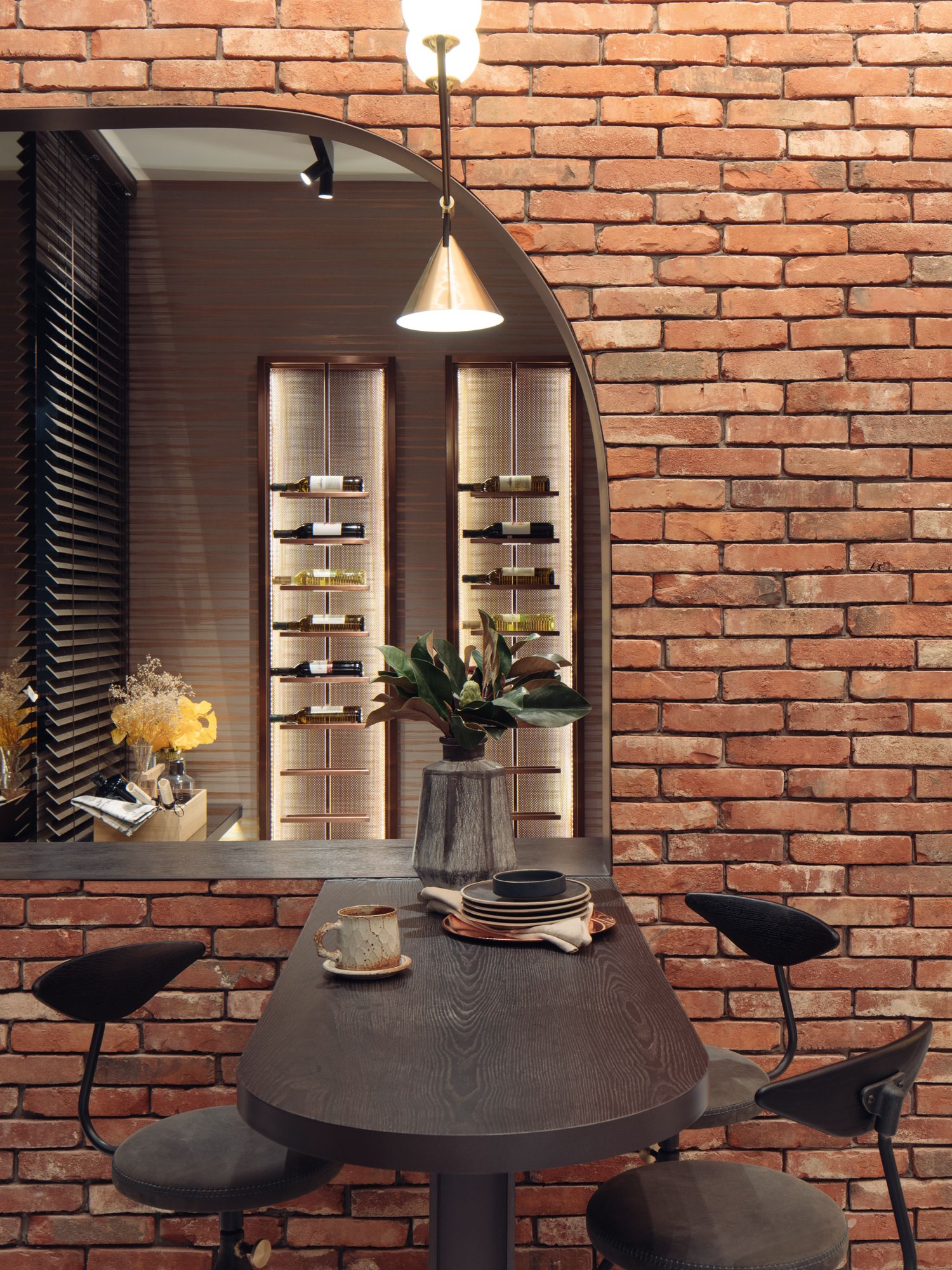 Exposed brickwork and a wine shelf display take you back to European vineyard hotel