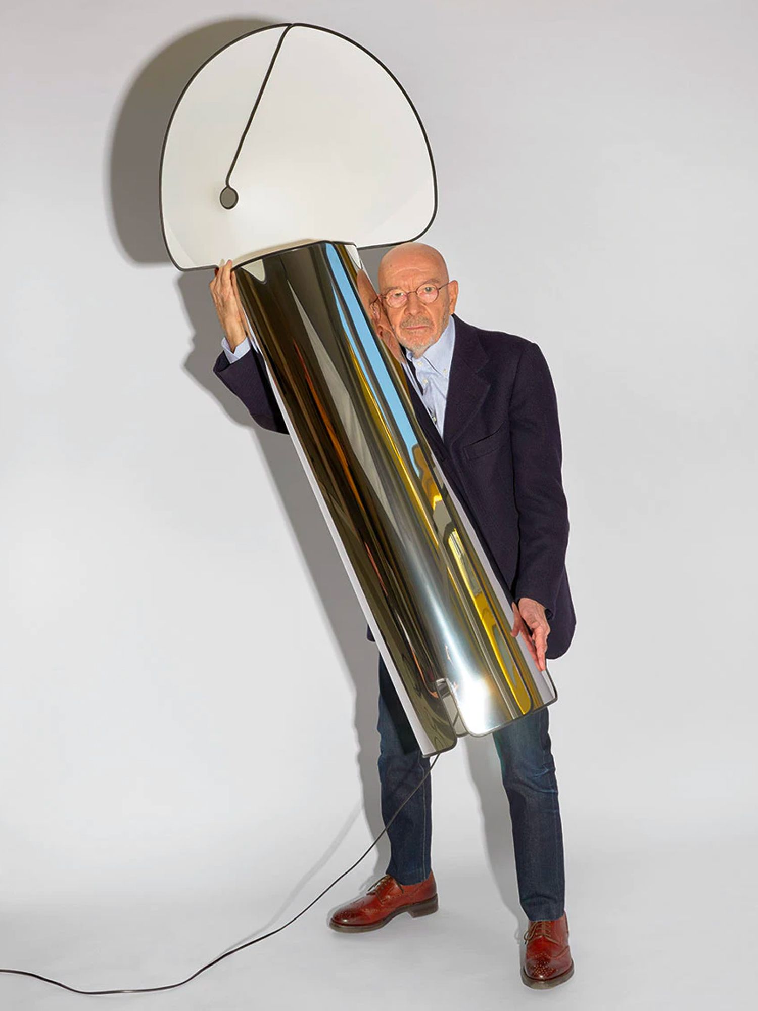 Mario Bellini, pictured with Flos' Chiara floor lamp Image: Courtesy of Flos