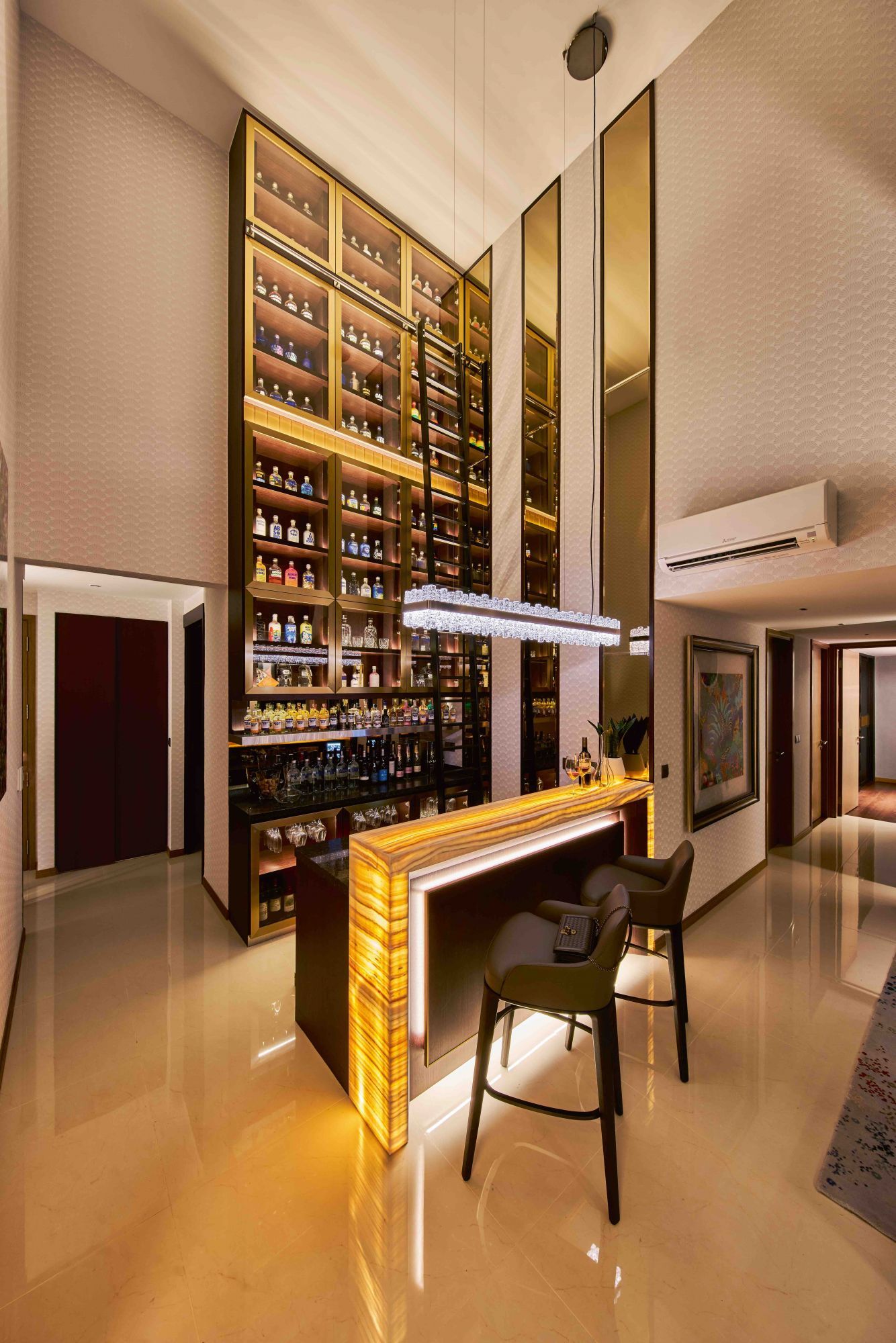 This show-stopping home bar designed by Prestige Global Designs allows the homeowner to showcase his extensive bottle collection Photography: Jasper Yu