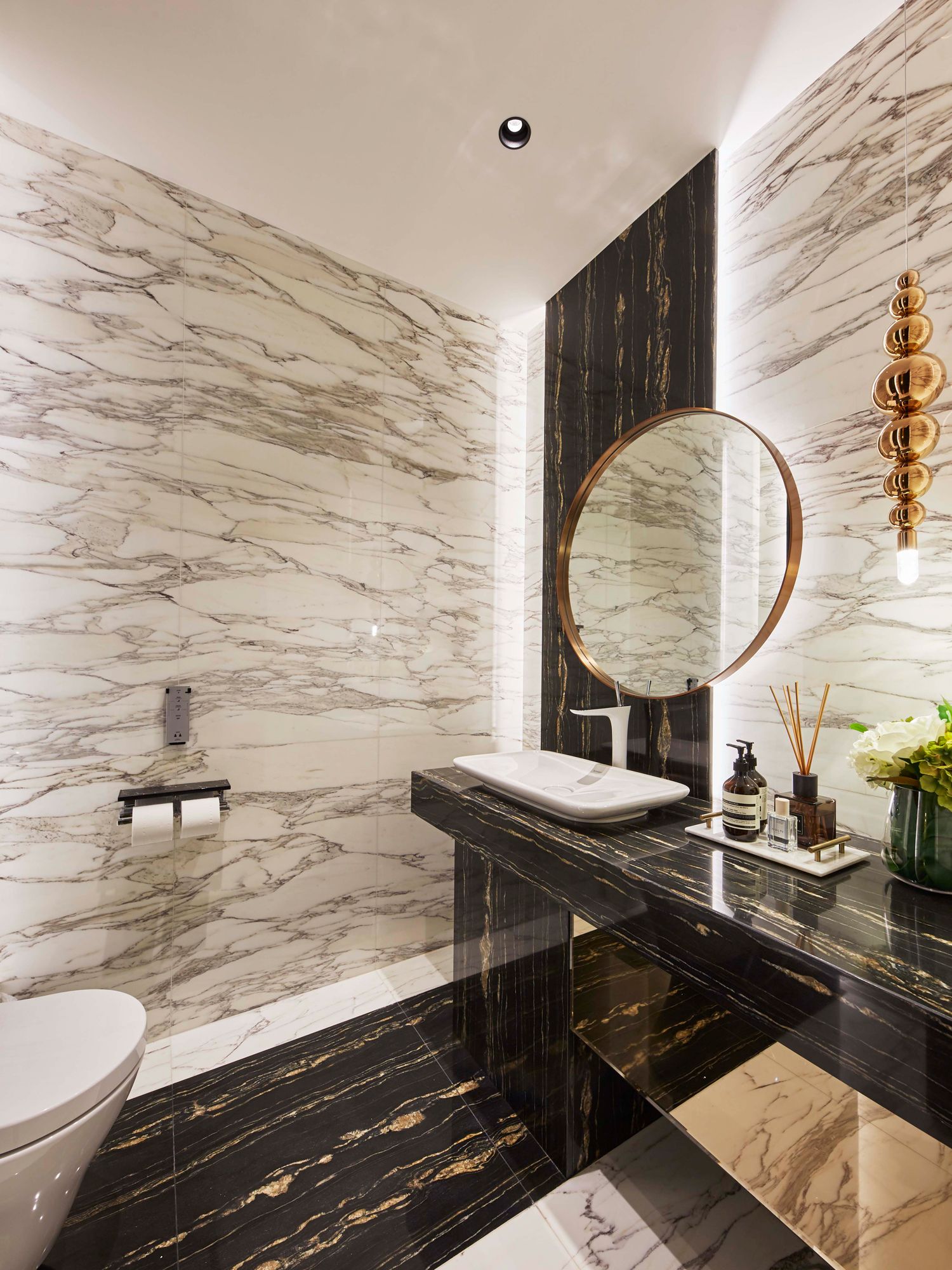 Clad in marble, the bathrooms exude a classic luxurious ambience