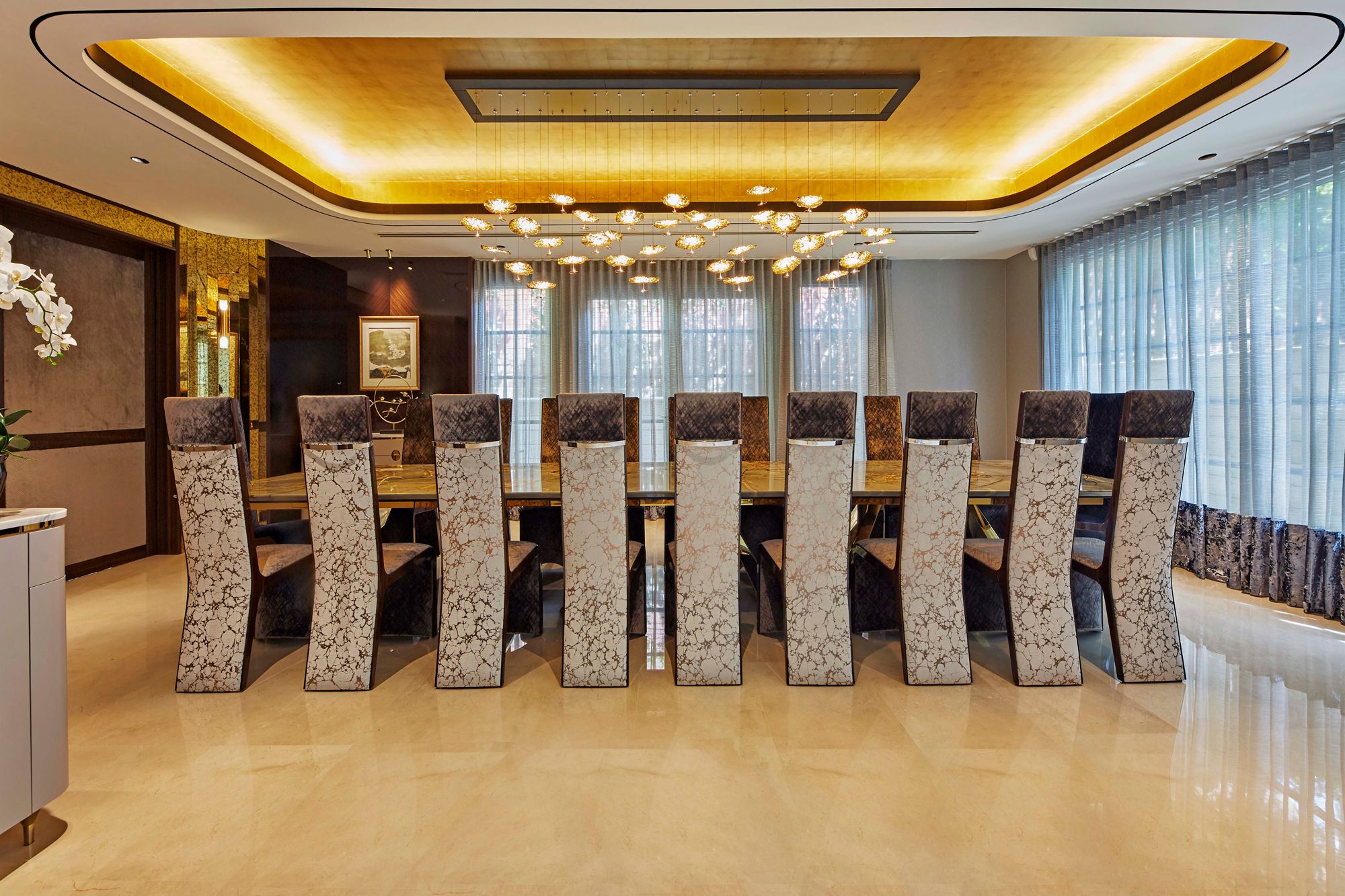 The formal dining room features a bespoke table and high-back dining chairs as requested by the client