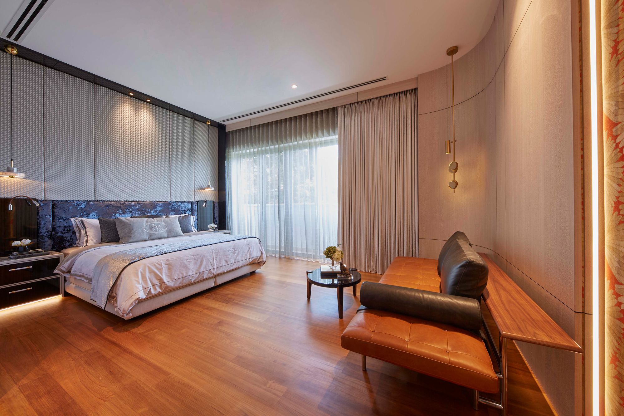 The master bedroom boasts a velvet headboard that adds texture and colour to the space