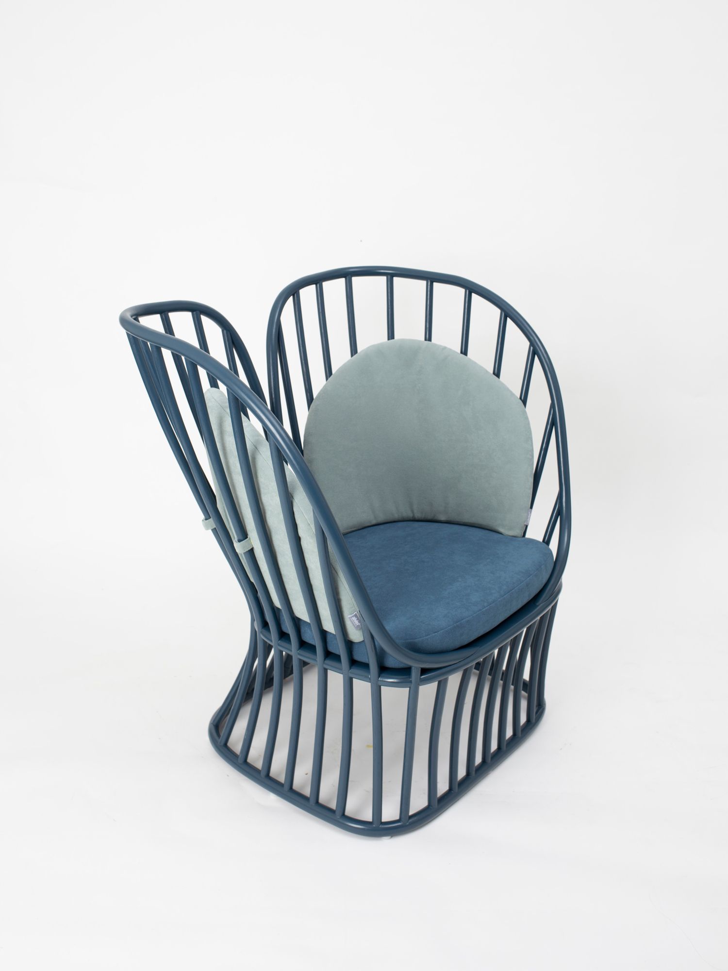 Designed not for sitting upright but rather for leaning to the side in comfort, the Bhuana Lounge Chair is crafted from natural rattan pole with a mahogany wood base